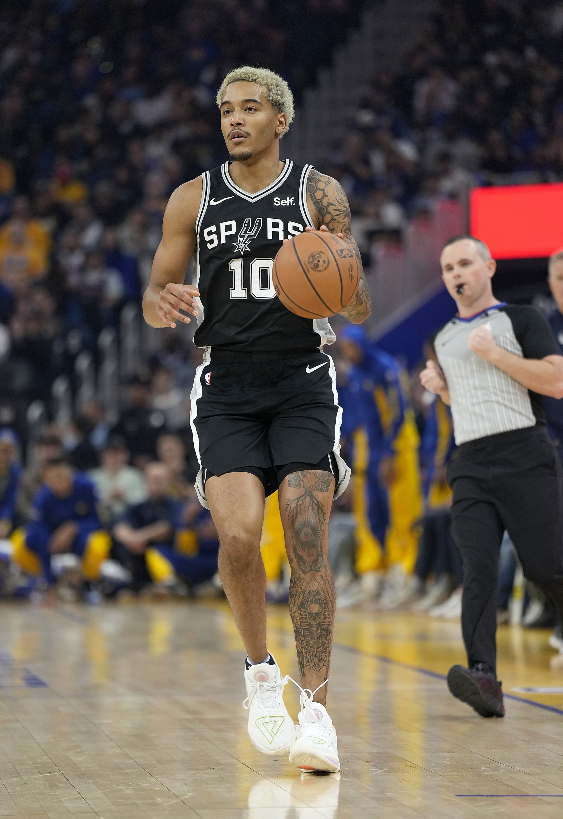 SAN FRANCISCO, CALIFORNIA - OCTOBER 20: Jeremy Sochan #10 of the San Antonio Spurs dribbles the ball up court against the Golden State Warriors during the first half of an NBA basketball game at Chase Center on October 20, 2023 in San Francisco, California. NOTE TO USER: User expressly acknowledges and agrees that, by downloading and or using this photograph, User is consenting to the terms and conditions of the Getty Images License Agreement. (Photo by Thearon W. Henderson/Getty Images)