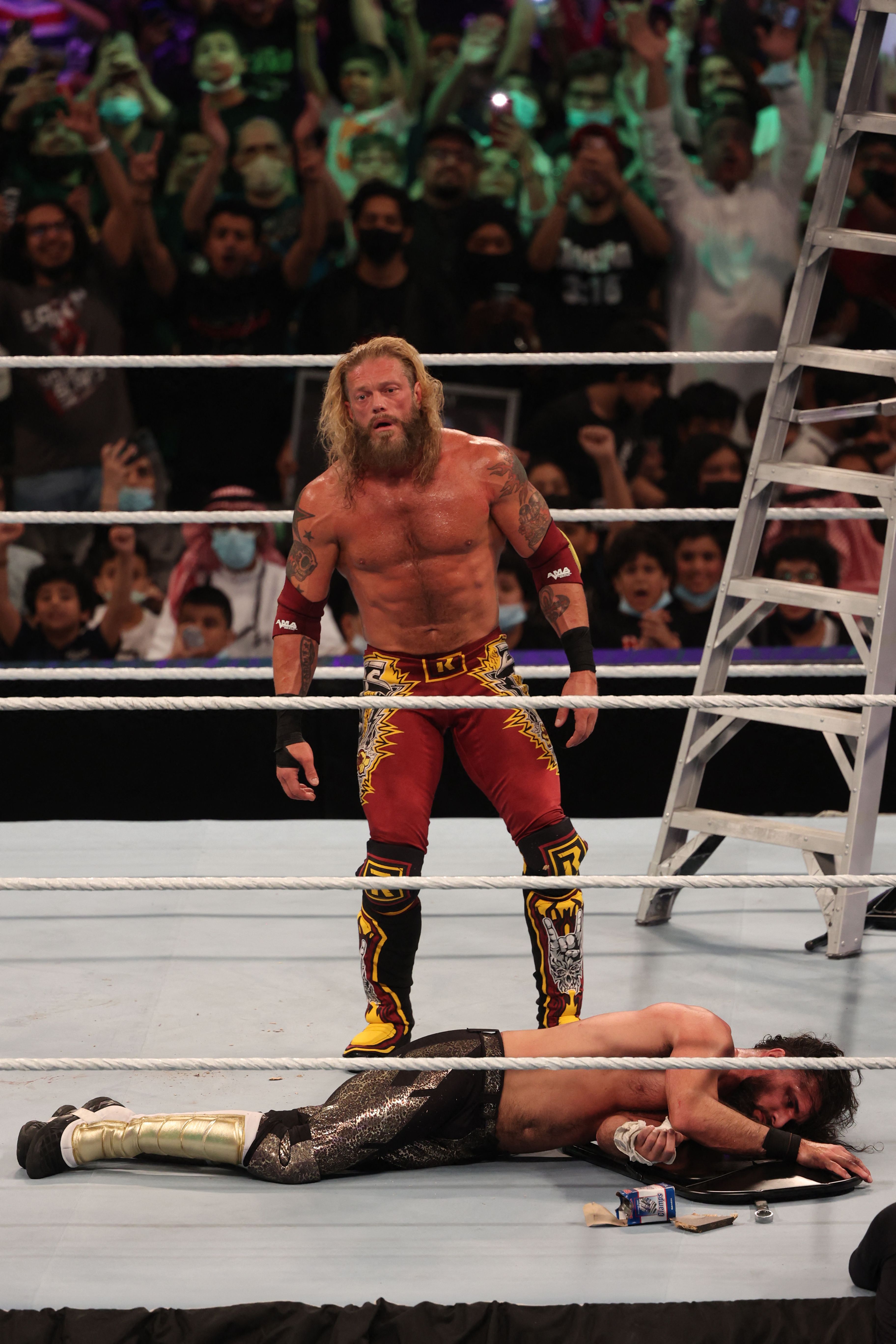 Edge stands over Seth Rollins after his win during the World Wrestling Entertainment (WWE) Crown Jewel pay-per-view in the Saudi capital Riyadh on October 21, 2021. (Photo by Fayez Nureldine / AFP) (Photo by FAYEZ NURELDINE/AFP via Getty Images)