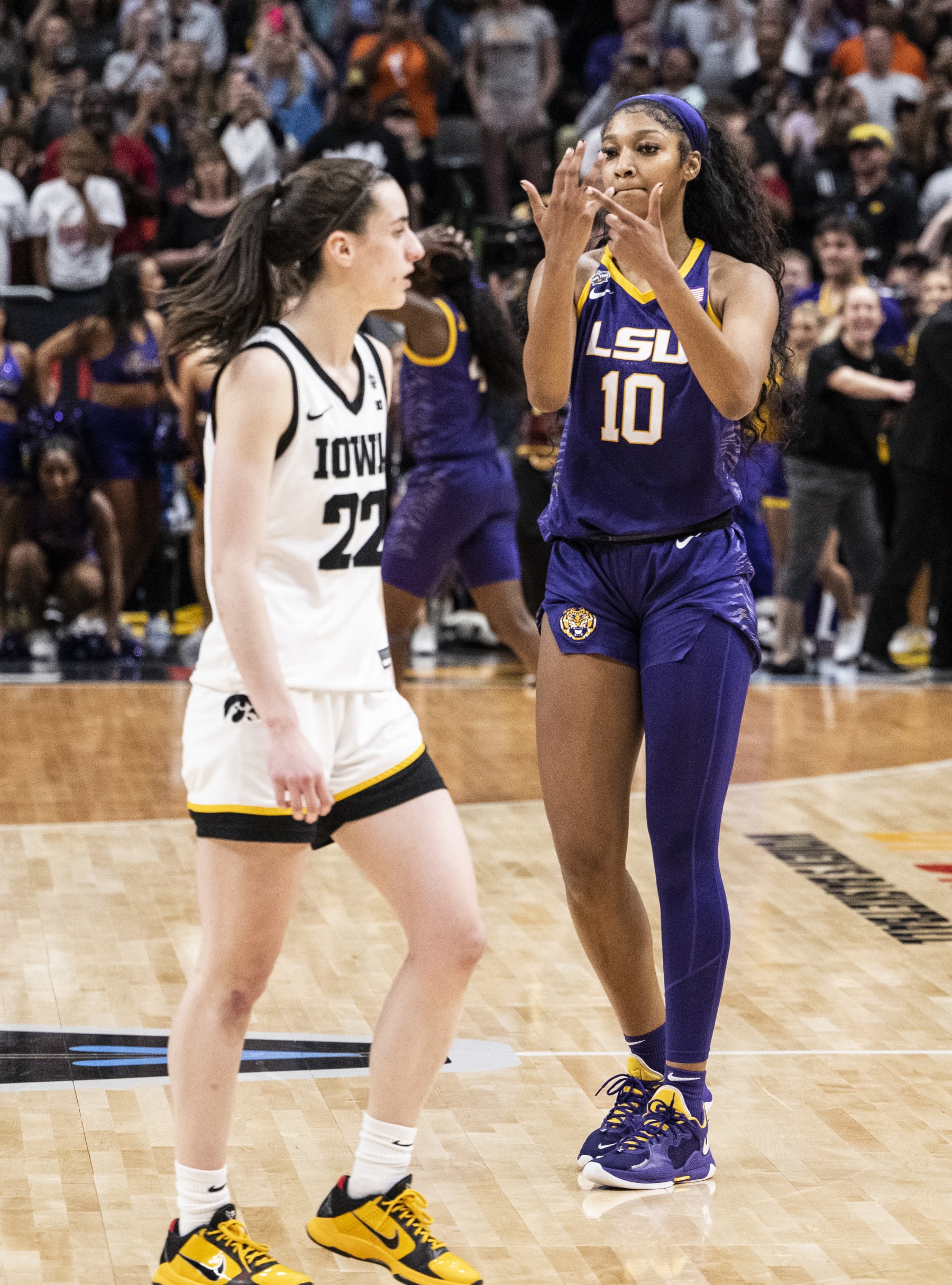 DALLAS, TEXAS - APRIL 02: Angel Reese #10 of the LSU Lady Tigers reacts in front of Caitlin Clark #22 of the Iowa Hawkeyes towards the end of the 2023 NCAA Women's Basketball Tournament championship game at American Airlines Center on April 02, 2023 in Dallas, Texas. (Photo by Ben Solomon/NCAA Photos via Getty Images)