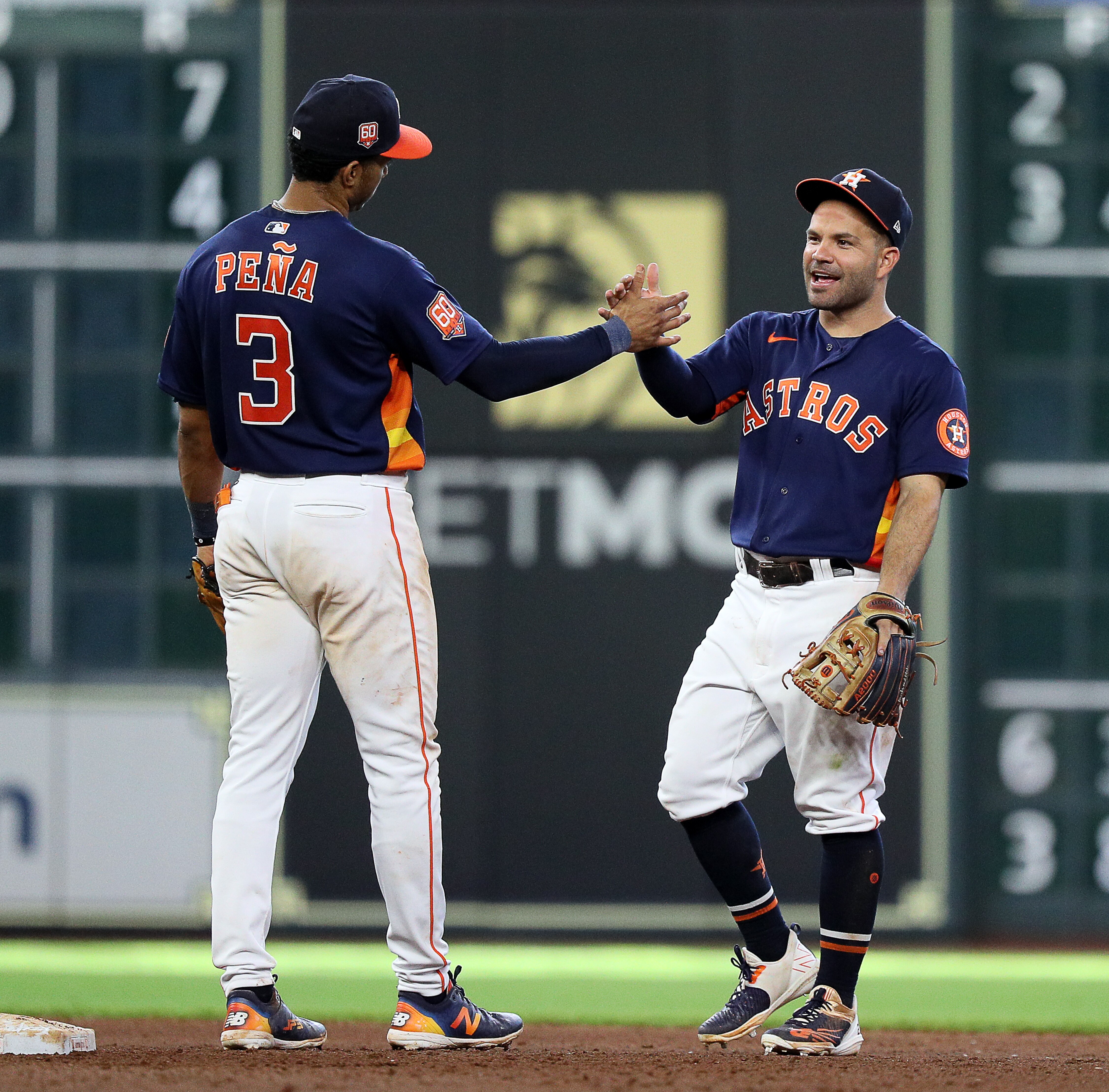 HOUSTON, TEXAS - JUNE 12: Jose Altuve #27 of the Houston Astros hugs Jeremy Pena #3 after defeating the Miami Marlins 9-4 at Minute Maid Park on June 12, 2022 in Houston, Texas. (Photo by Bob Levey/Getty Images)