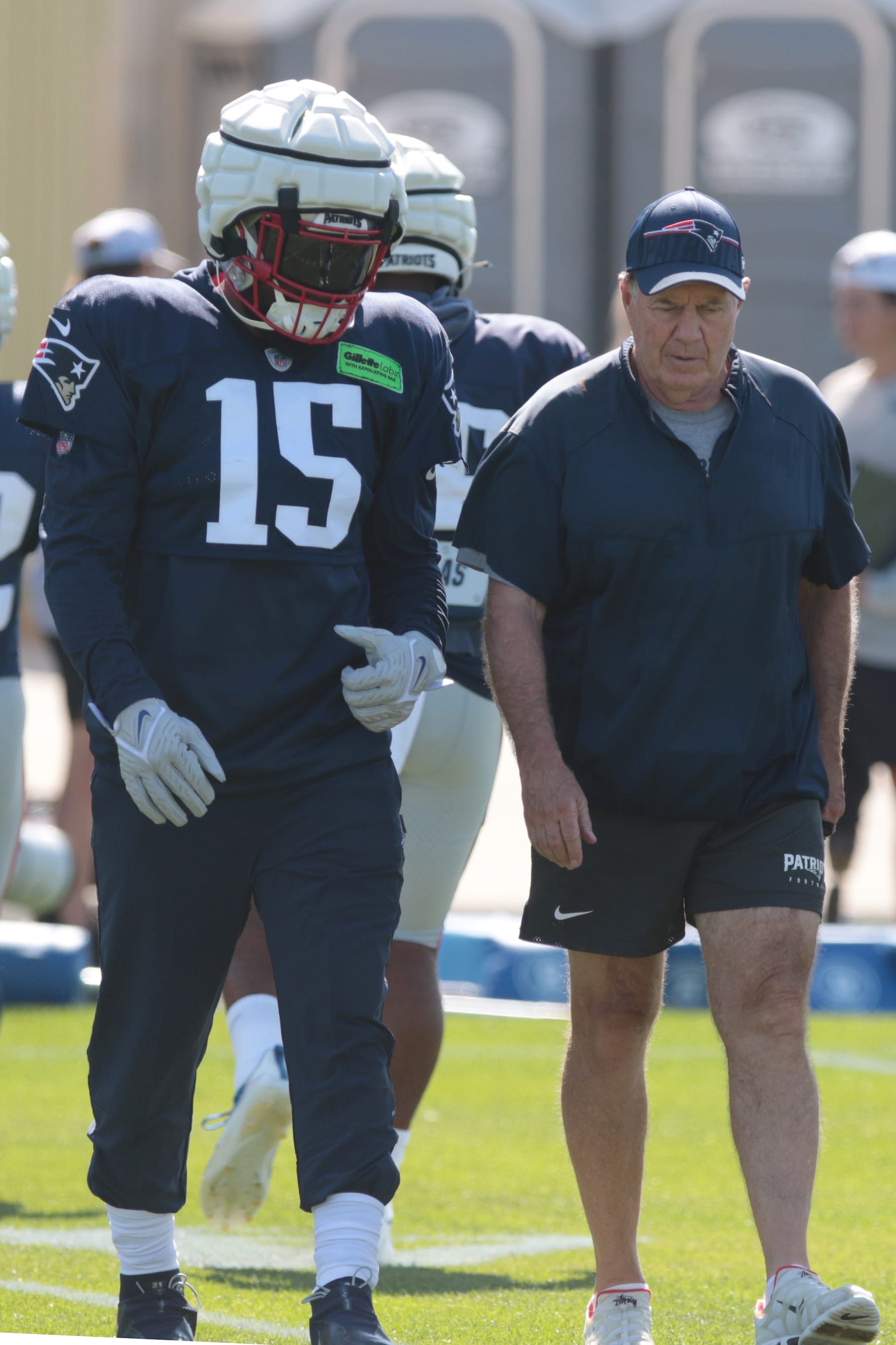 ASHWAUBENON, WI - AUGUST 16: New England Patriots head coach Bill Belichick walks with New England Patriots running back Ezekiel Elliott (15) during a joint training camp practice between the Green Bay Packers and the New England Patriots at Ray Nitschke Field on August 16, 2023 in Ashwaubenon, WI. (Photo by Larry Radloff/Icon Sportswire via Getty Images)