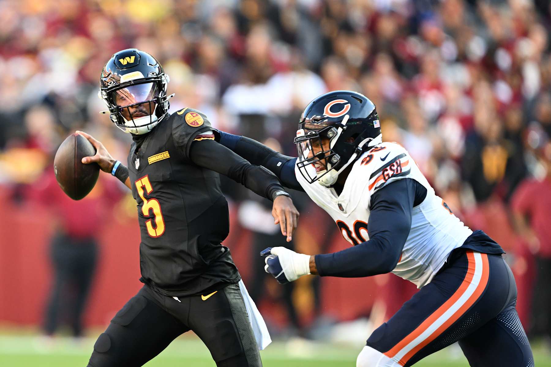 LANDOVER, MARYLAND - OCTOBER 27: Jayden Daniels #5 of the Washington Commanders is hit by Montez Sweat #98 of the Chicago Bears during the first quarter at Northwest Stadium on October 27, 2024 in Landover, Maryland. (Photo by Greg Fiume/Getty Images)
