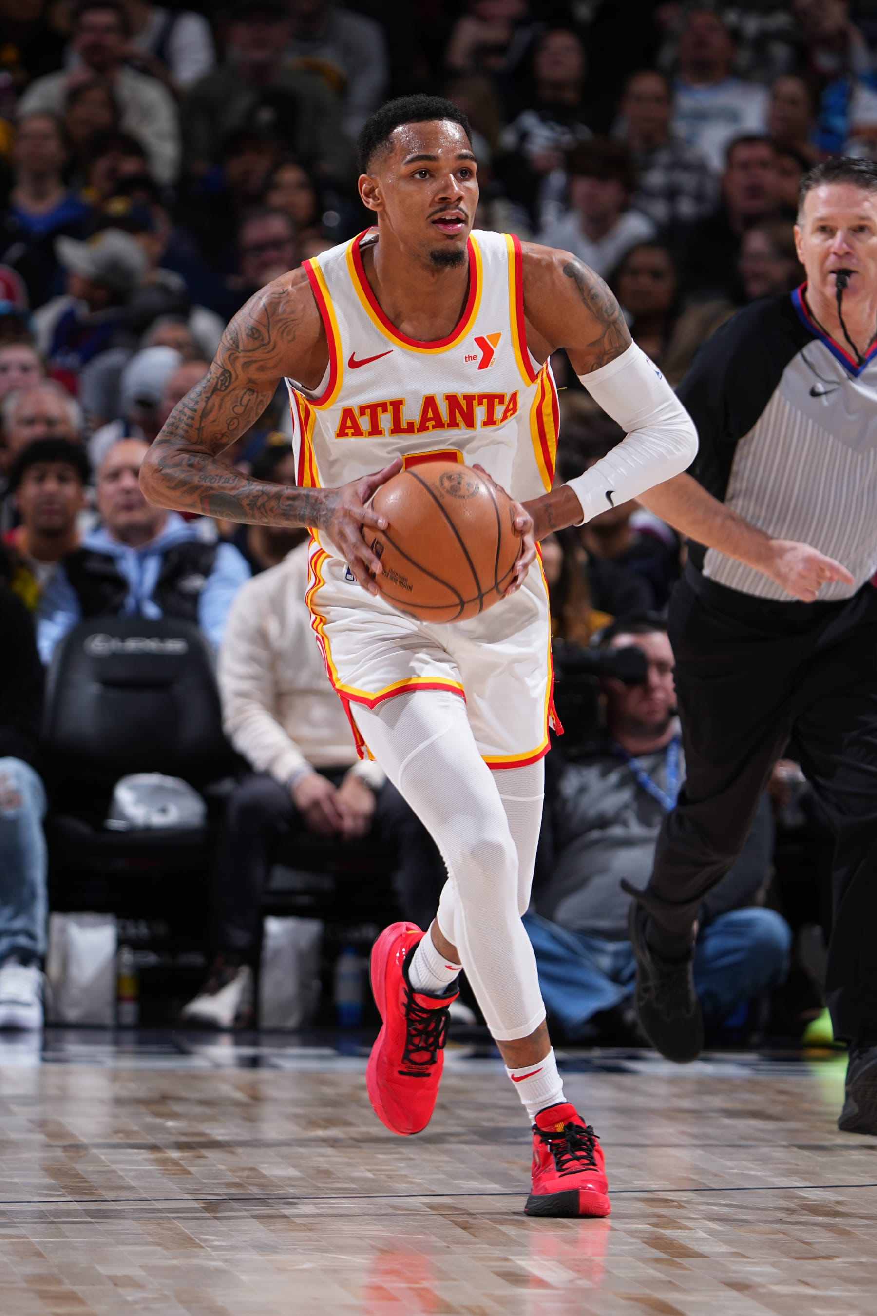 DENVER, CO - APRIL 6: Dejounte Murray #5 of the Atlanta Hawks passes the ball during the game against the Denver Nuggets on April 6, 2024 at the Ball Arena in Denver, Colorado. NOTE TO USER: User expressly acknowledges and agrees that, by downloading and/or using this Photograph, user is consenting to the terms and conditions of the Getty Images License Agreement. Mandatory Copyright Notice: Copyright 2024 NBAE (Photo by Garrett Ellwood/NBAE via Getty Images)