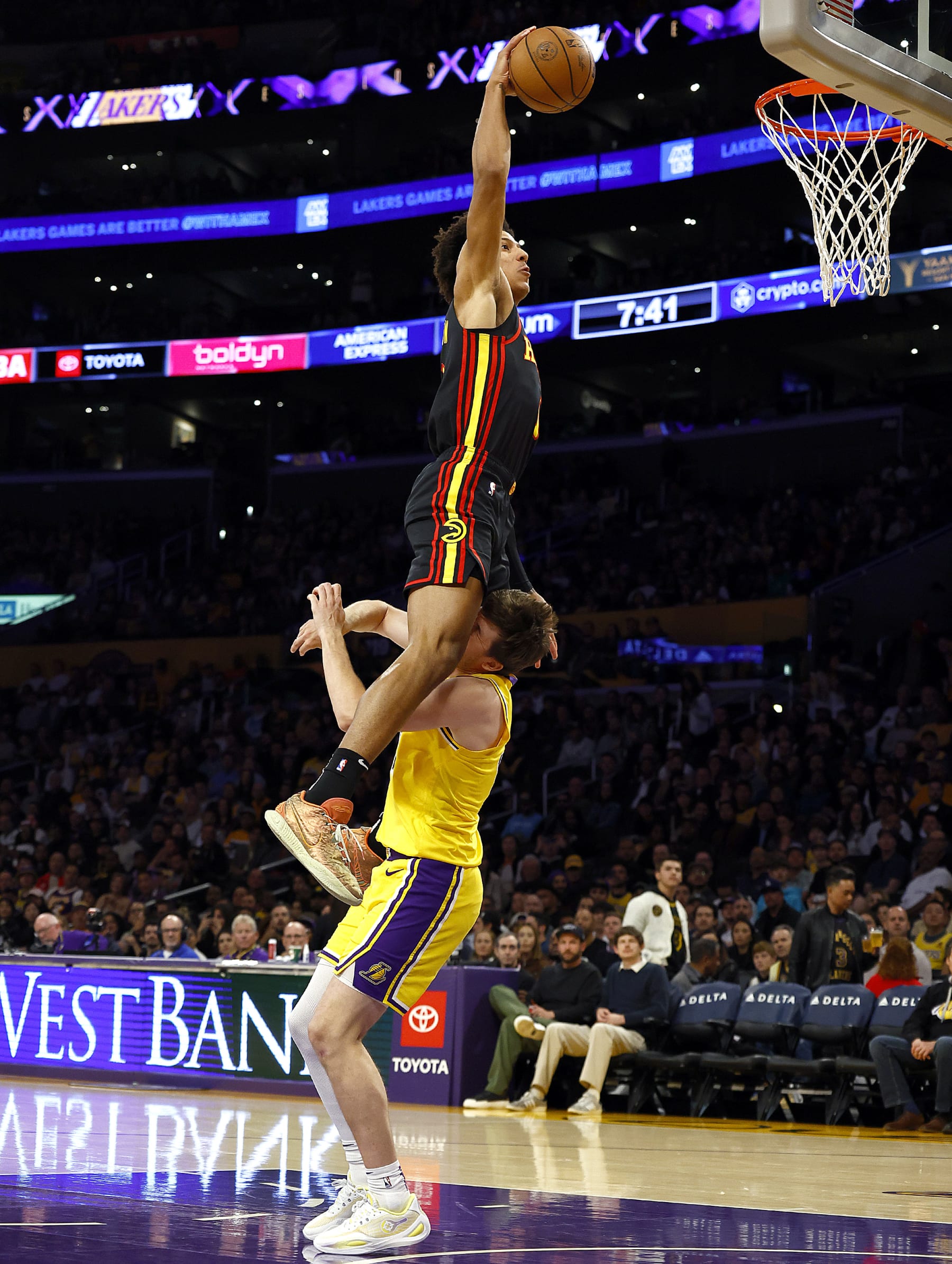 LOS ANGELES, CALIFORNIA - MARCH 18: Jalen Johnson #1 of the Atlanta Hawks makes the slam dunk and fouled by Austin Reaves #15 of the Los Angeles Lakers in the first half at Crypto.com Arena on March 18, 2024 in Los Angeles, California. NOTE TO USER: User expressly acknowledges and agrees that, by downloading and/or using this photograph, user is consenting to the terms and conditions of the Getty Images License Agreement. (Photo by Ronald Martinez/Getty Images)