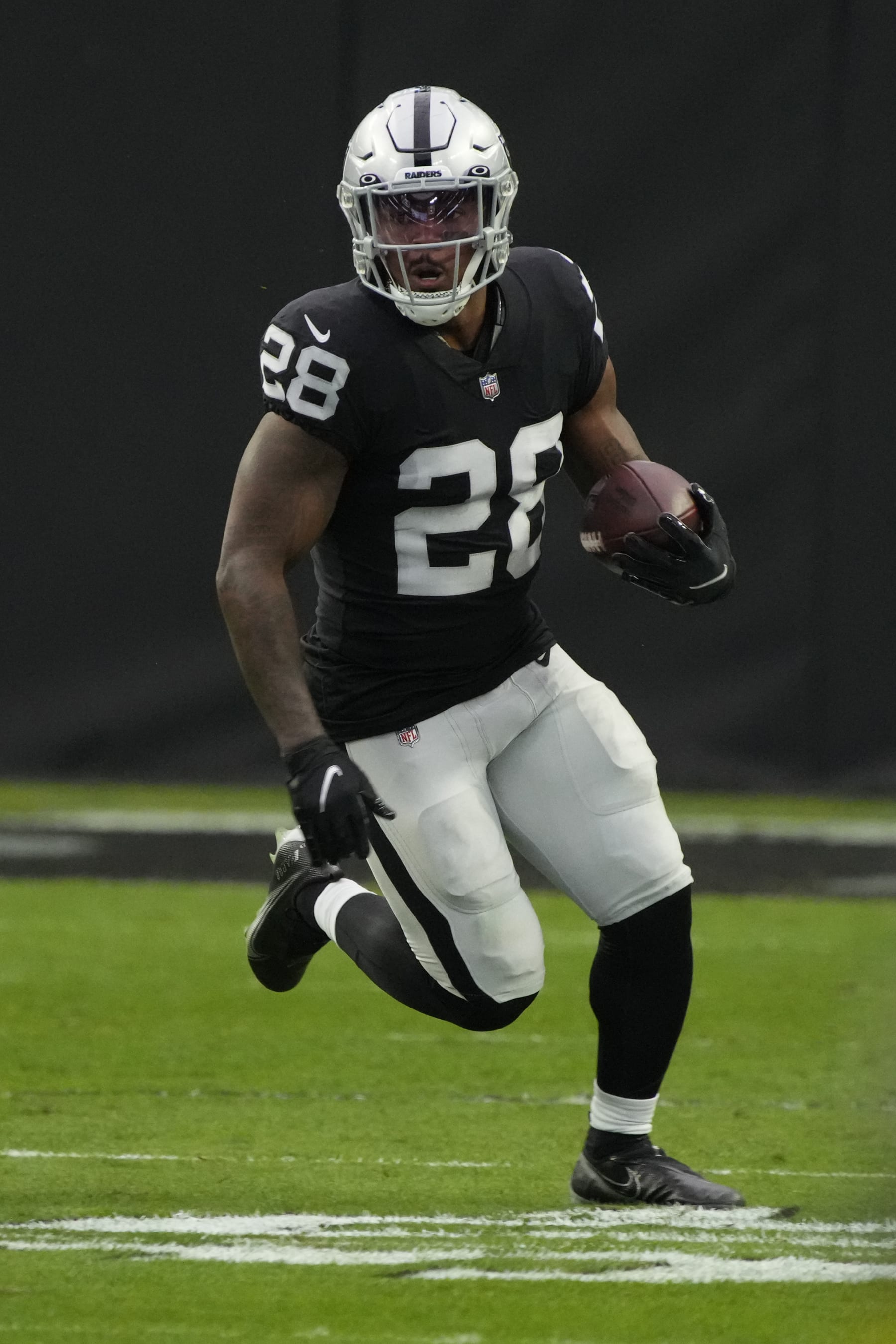 Las Vegas Raiders running back Josh Jacobs (28) runs the ball against the Indianapolis Colts during the first half of an NFL football game, Sunday, Nov 13, 2022, in Las Vegas. (AP Photo/Rick Scuteri)