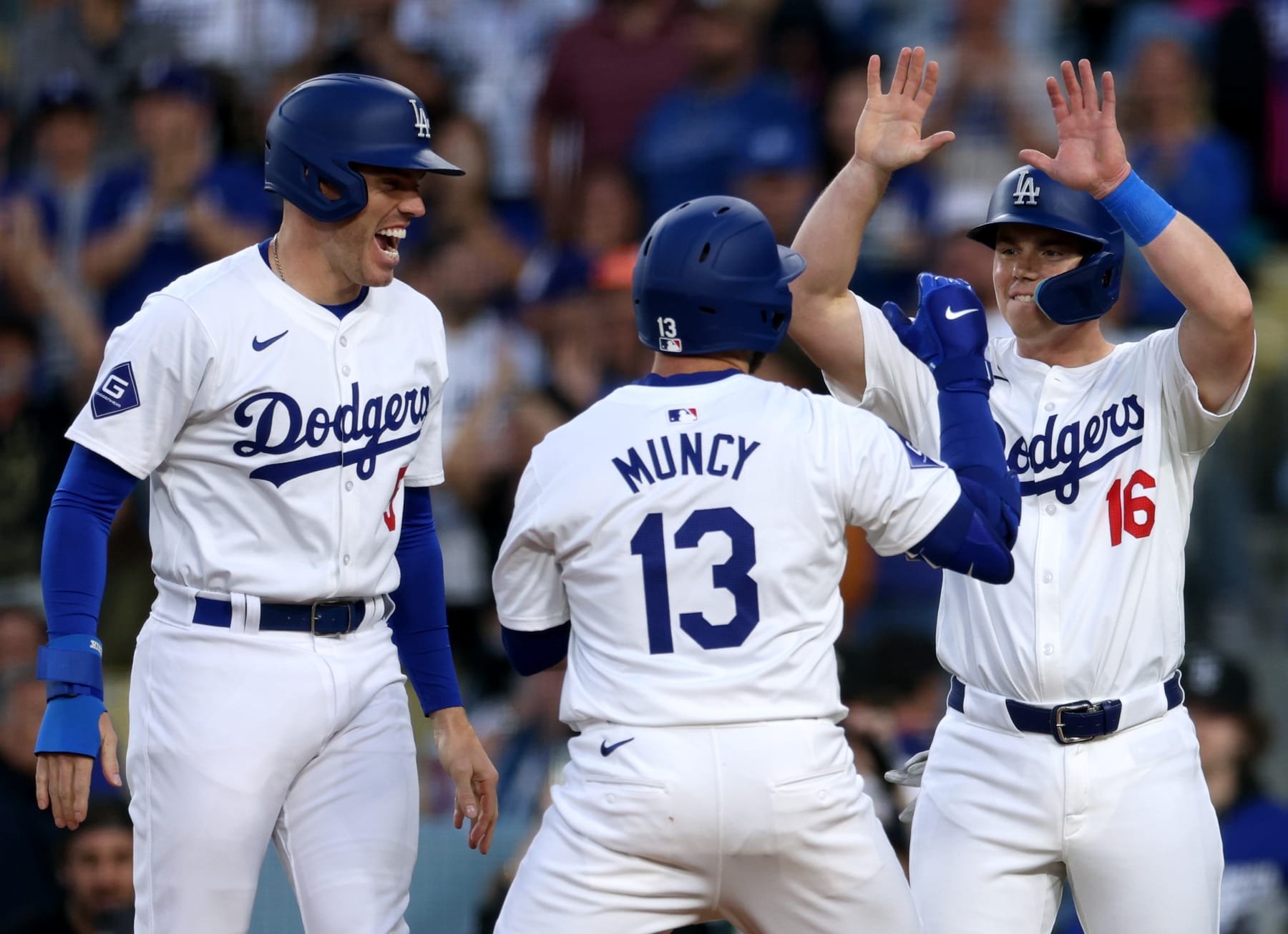 LOS ANGELES, CALIFORNIA - MAY 07: Max Muncy #13 of the Los Angeles Dodgers celebrates his grand slam home run with Freddie Freeman #5 and Will Smith #16, to take a 4-3 lead over the Miami Marlins, during the first inning at Dodger Stadium on May 07, 2024 in Los Angeles, California. (Photo by Harry How/Getty Images)