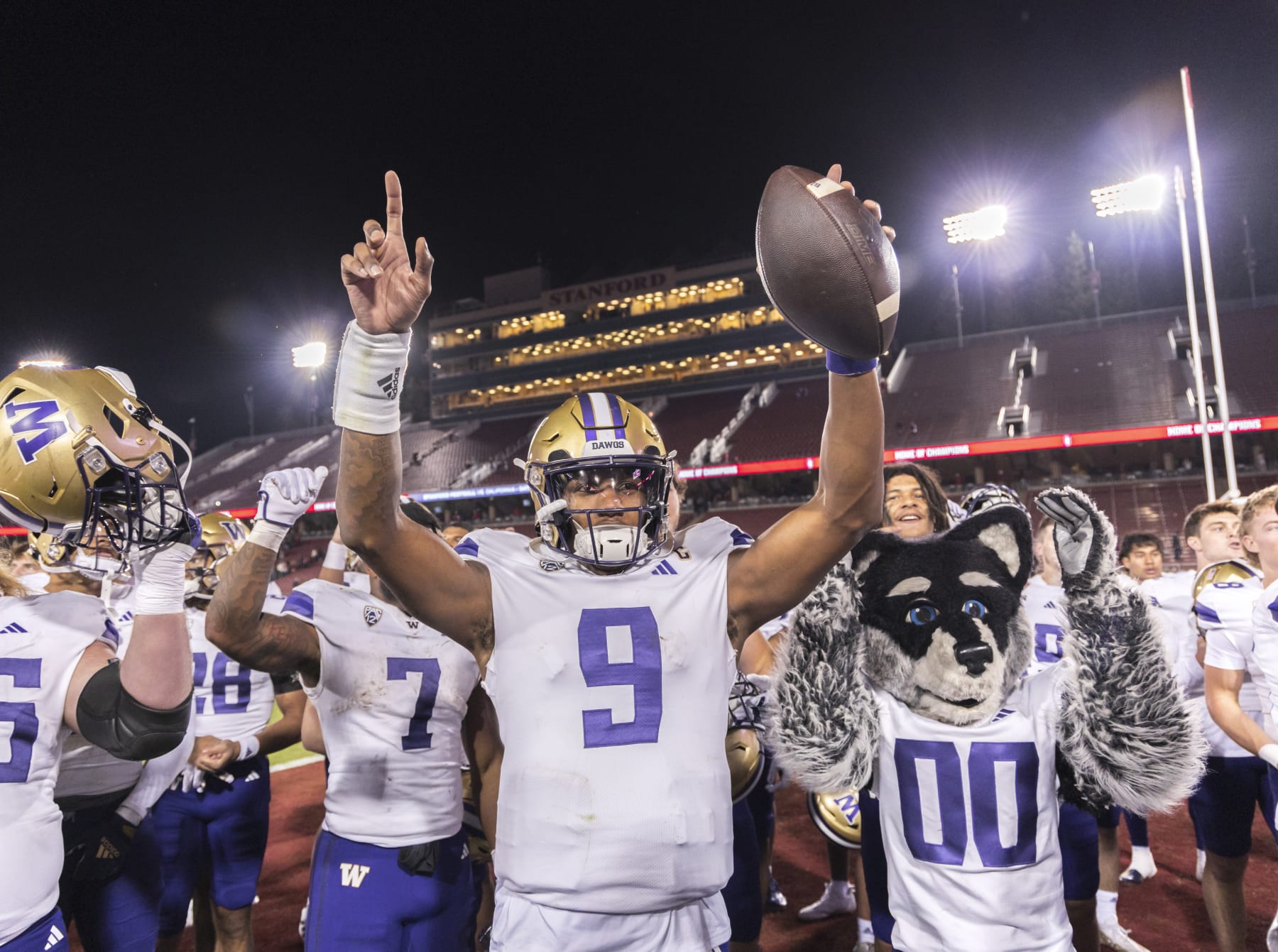PALO ALTO, CA - OCTOBER  28:  Quarterback Michael Penix, Jr #9 of the Washington Huskies and teammates and mascot Harry The Husky #00 celebrate Washington's win over the Stanford Cardinal in a Pac-12 NCAA college football game on October 28, 2023 at Stanford Stadium in Palo Alto, California.  (Photo by David Madison/Getty Images)