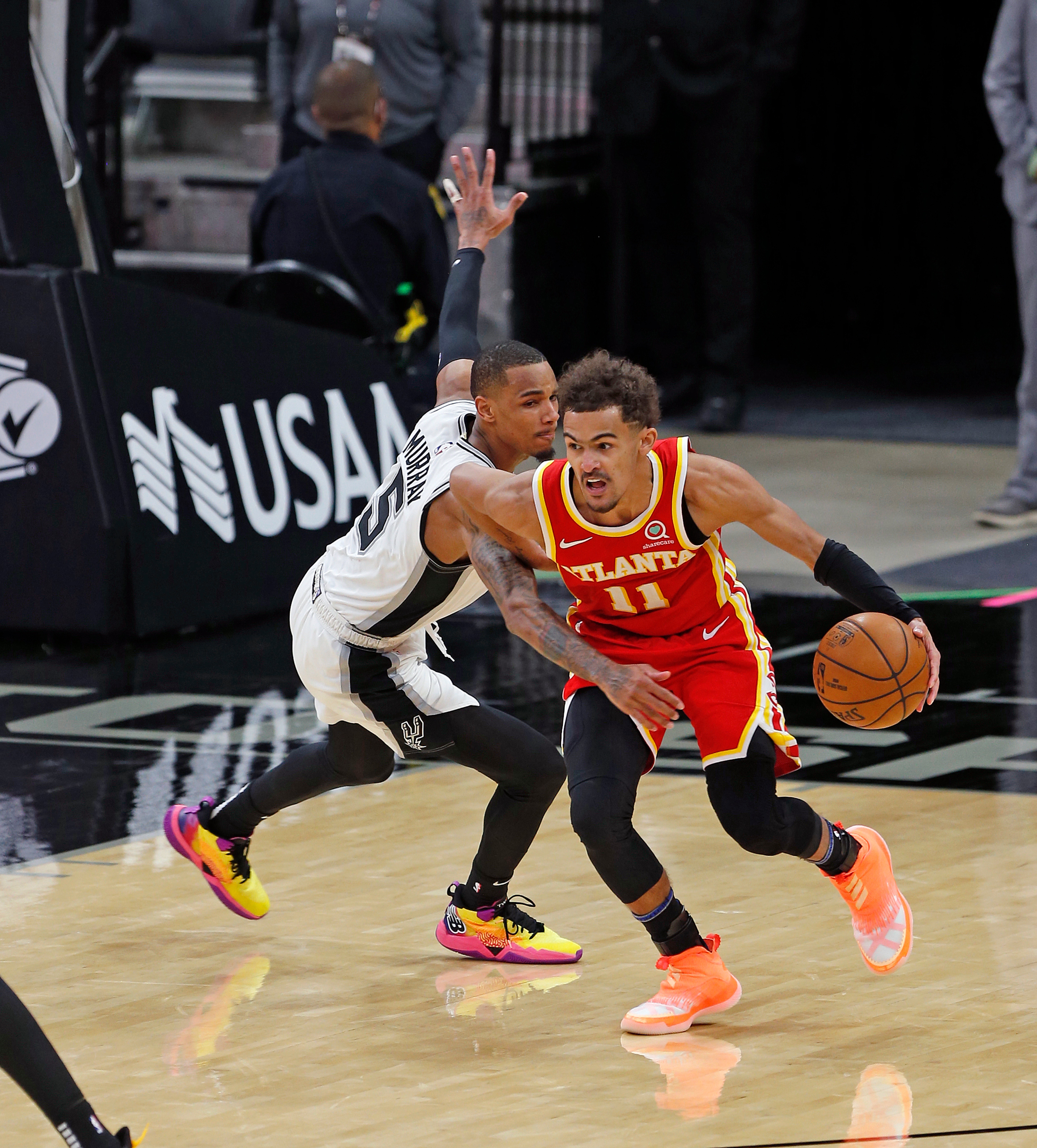 SAN ANTONIO, TX - APRIL 01:  Dejounte Murray #5 of the San Antonio Spurs tries to press Trae Young #11 of the Atlanta Hawks  in the second half at AT&T Center on April 1, 2021 in San Antonio, Texas.  NOTE TO USER: User expressly acknowledges and agrees that , by downloading and or using this photograph, User is consenting to the terms and conditions of the Getty Images License Agreement. (Photo by Ronald Cortes/Getty Images)