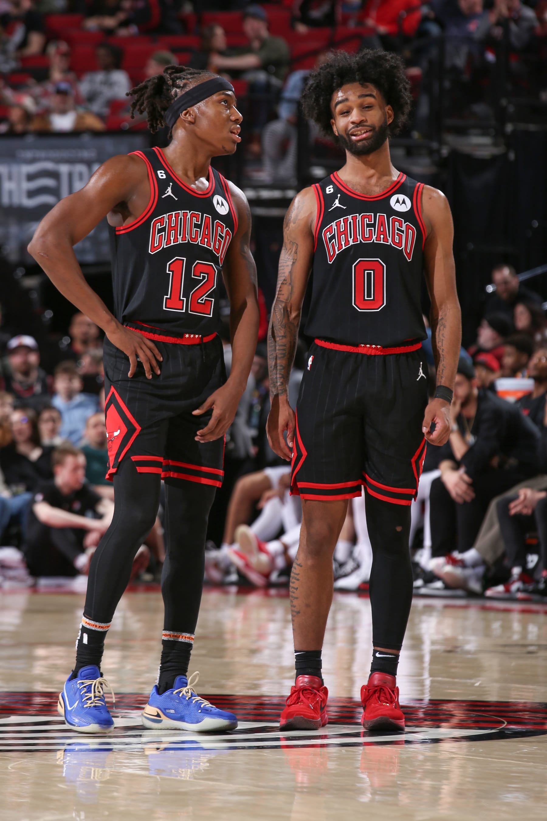 PORTLAND, OR - MARCH 24:  Ayo Dosunmu #12 and Coby White #0 of the Chicago Bulls looks on during the game on March 24, 2023 at the Moda Center Arena in Portland, Oregon. NOTE TO USER: User expressly acknowledges and agrees that, by downloading and or using this photograph, user is consenting to the terms and conditions of the Getty Images License Agreement. Mandatory Copyright Notice: Copyright 2023 NBAE (Photo by Cameron Browne/NBAE via Getty Images)