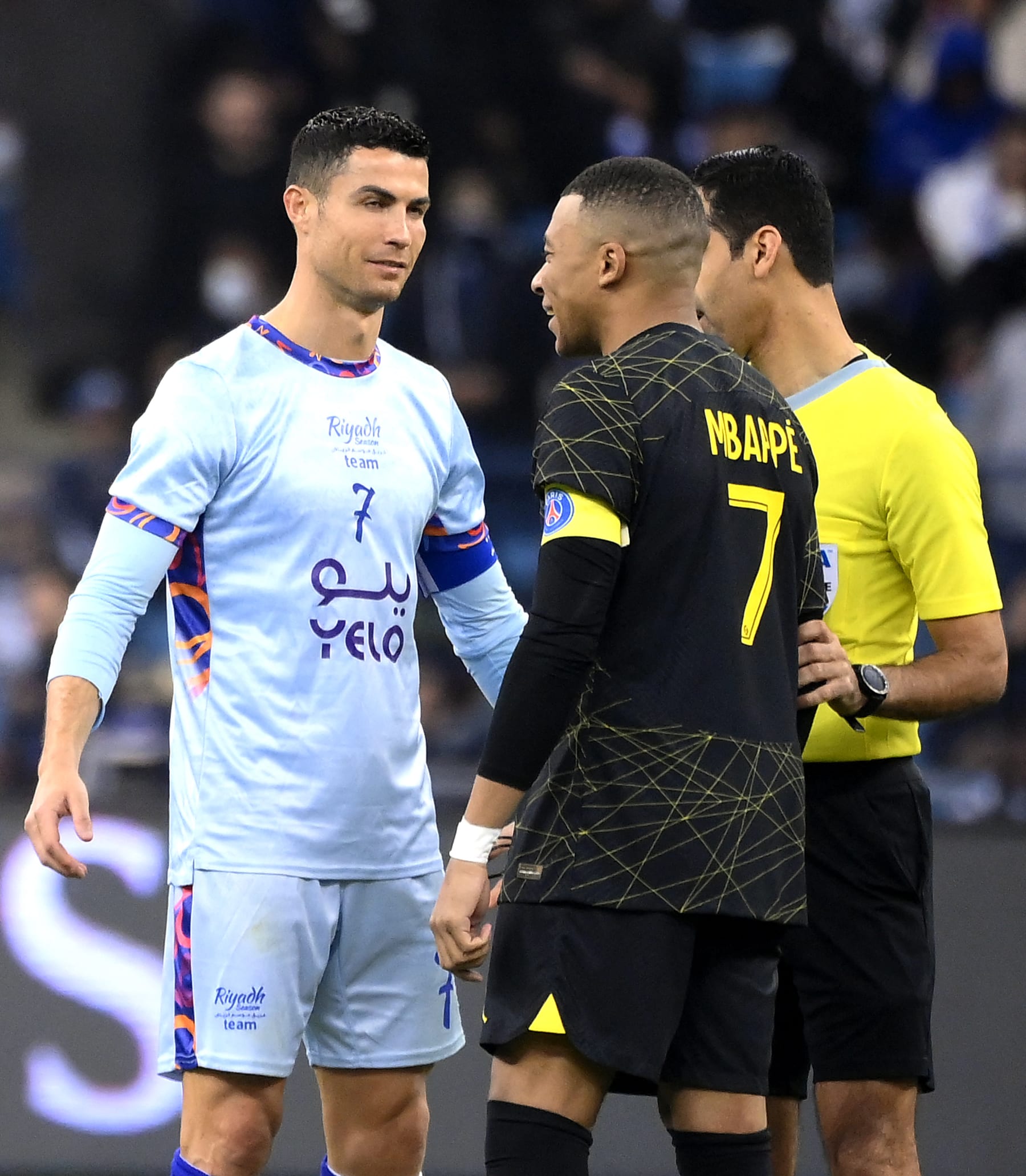 Riyadh All-Star's Portuguese forward Cristiano Ronaldo (L) chats with Paris Saint-Germain's French forward Kylian Mbappe (R) during the Riyadh Season Cup football match between the Riyadh All-Stars and Paris Saint-Germain at the King Fahd Stadium in Riyadh on January 19, 2023. (Photo by FRANCK FIFE / AFP) (Photo by FRANCK FIFE/AFP via Getty Images)