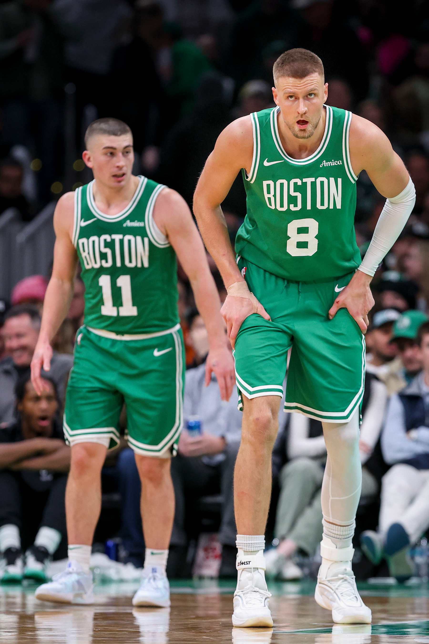 BOSTON, MA - DECEMBER 12: Kristaps Porzingis #8 and Payton Pritchard #11 of the Boston Celtics react during a game against the Detroit Pistons at TD Garden on December 12, 2024 in Boston, Massachusetts. NOTE TO USER: User expressly acknowledges and agrees that, by downloading and or using this photograph, User is consenting to the terms and conditions of the Getty Images License Agreement. (Photo by Adam Glanzman/Getty Images)