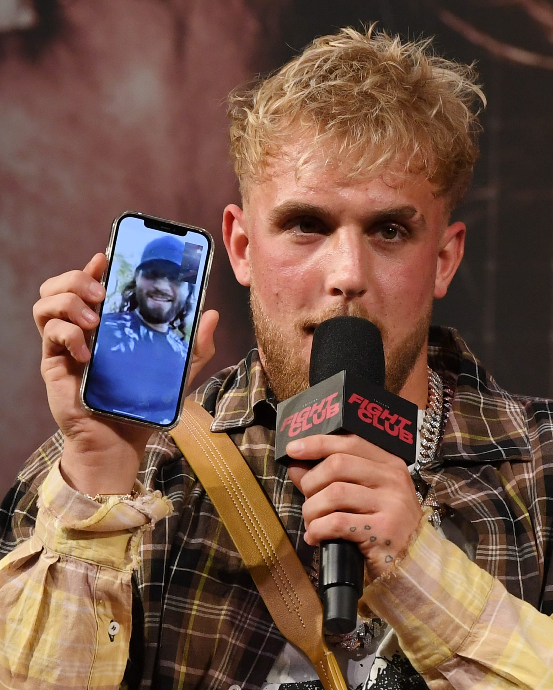 LAS VEGAS, NEVADA - MARCH 26:  Jake Paul talks to mixed martial artist Jorge Masvidal on his cell phone during a news conference for Triller Fight Club's inaugural 2021 boxing event at The Venetian Las Vegas on March 26, 2021 in Las Vegas, Nevada. Paul will face Ben Askren, who was knocked out by Masvidal in UFC 239 in 2019, in the main event that will take place on April 17, 2021, at Mercedes-Benz Stadium in Atlanta.  (Photo by Ethan Miller/Getty Images)
