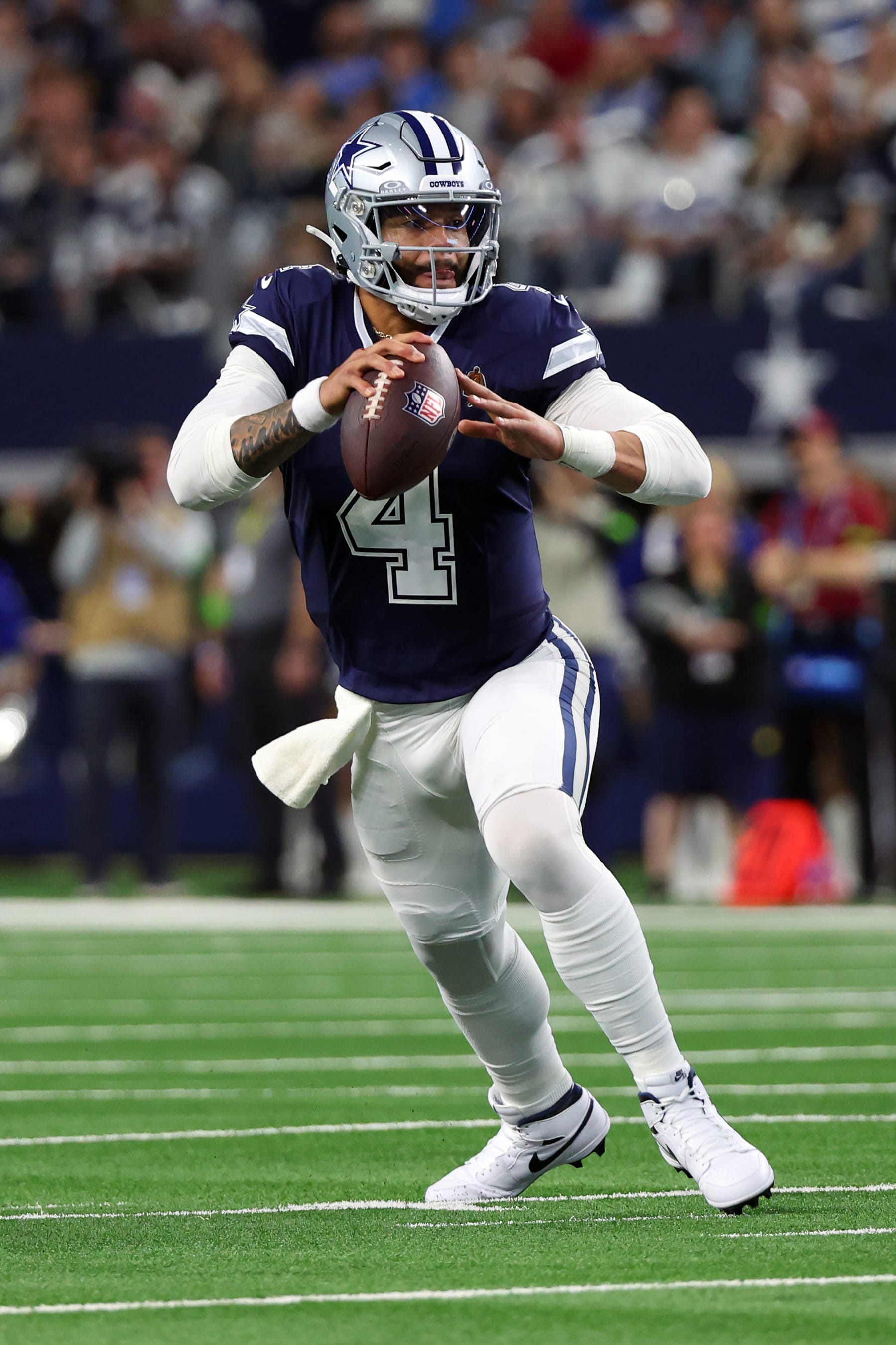 ARLINGTON, TEXAS - DECEMBER 30: Quarterback Dak Prescott #4 of the Dallas Cowboys scrambles with the football against the Detroit Lions at AT&T Stadium on December 30, 2023 in Arlington, Texas. (Photo by Richard Rodriguez/Getty Images)