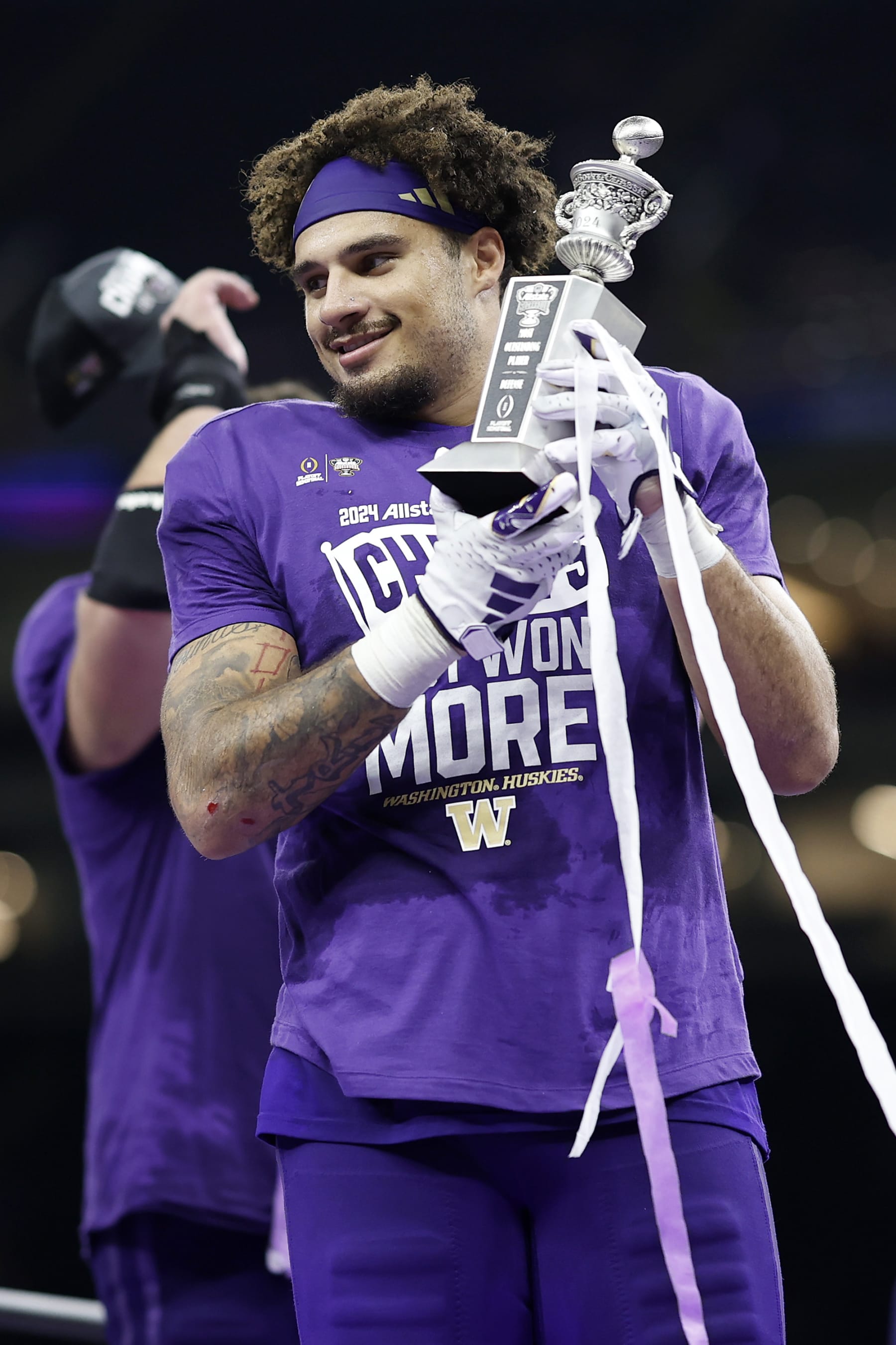 NEW ORLEANS, LOUISIANA - JANUARY 01: Bralen Trice #8 of the Washington Huskies celebrates after a 37-31 victory against the Texas Longhorns in the CFP Semifinal Allstate Sugar Bowl at Caesars Superdome on January 01, 2024 in New Orleans, Louisiana. (Photo by Chris Graythen/Getty Images)