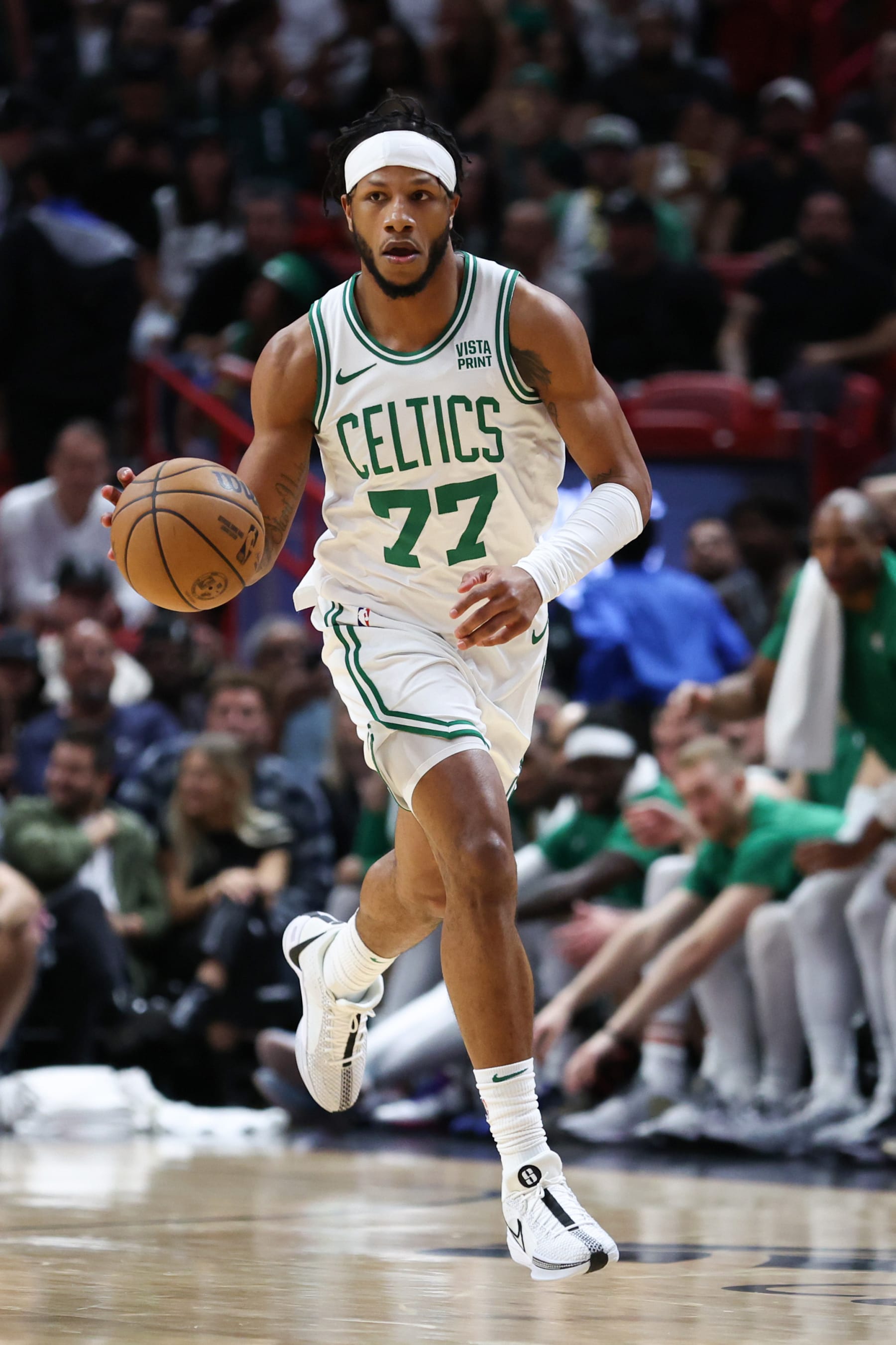 MIAMI, FLORIDA - JANUARY 25: Lamar Stevens #77 of the Boston Celtics dribbles the ball against the Miami Heat during the fourth quarter of the game at Kaseya Center on January 25, 2024 in Miami, Florida. NOTE TO USER: User expressly acknowledges and agrees that, by downloading and or using this photograph, User is consenting to the terms and conditions of the Getty Images License Agreement. (Photo by Megan Briggs/Getty Images)