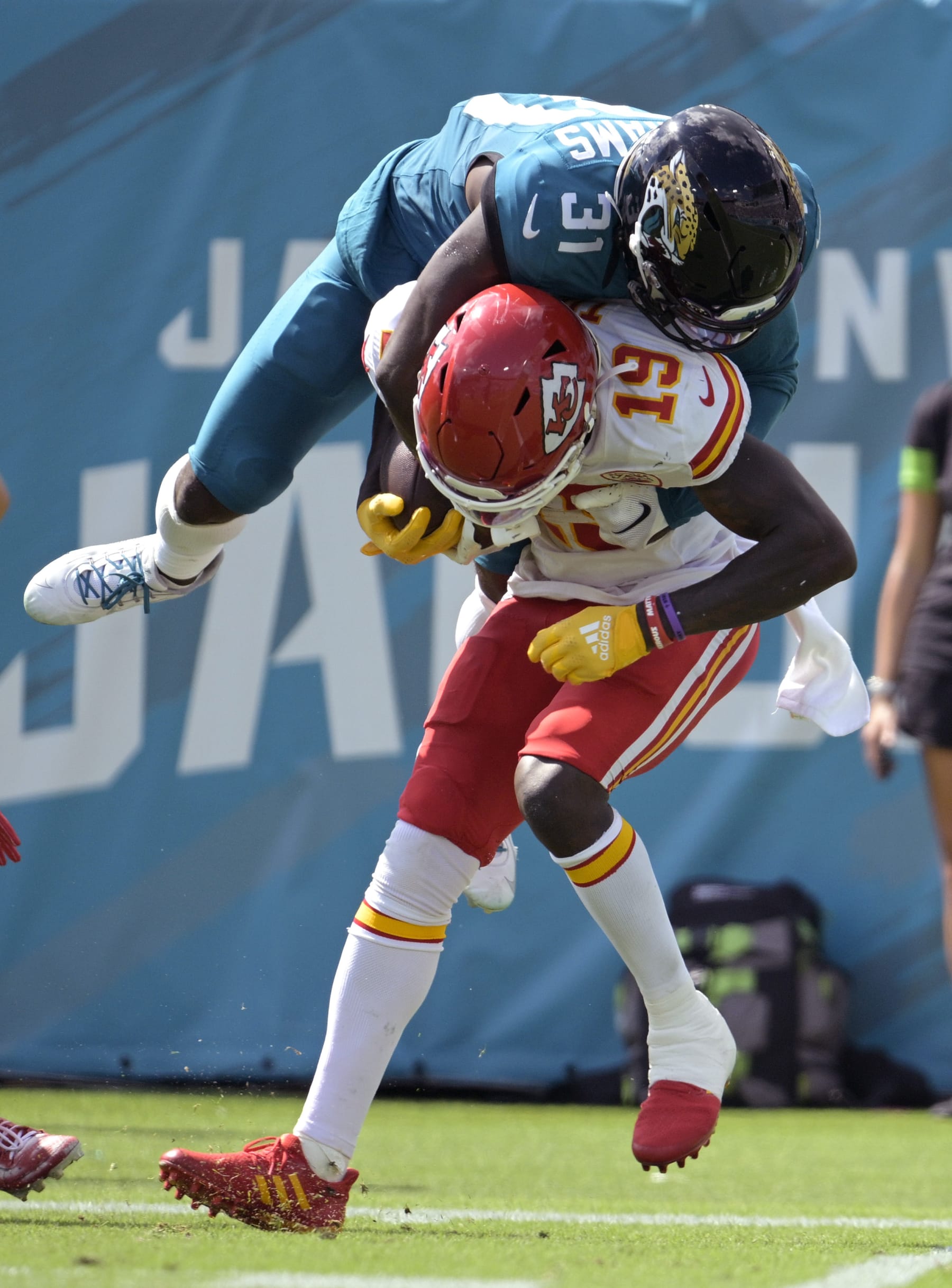 Kansas City Chiefs wide receiver Kadarius Toney (19) is hit by Jacksonville Jaguars cornerback Darious Williams (31) after a catch during the second half of an NFL football game, Sunday, Sept. 17, 2023, in Jacksonville, Fla. (AP Photo/Phelan M. Ebenhack)