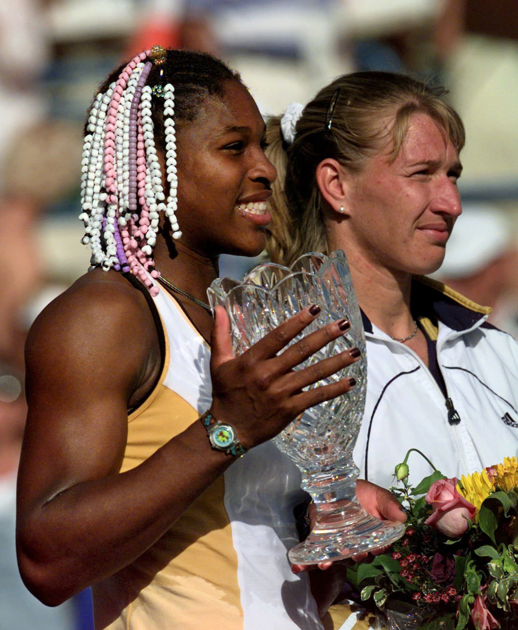 FILE - In this March 13, 1999, file photo, Serena Williams, from Palm Beach Gardens, Fla., holds the Evert Cup tennis tournament trophy as she stands alongside Germany's Steffi Graf after winning 6-3, 3-6, 7-5 in Indian Wells, Calif. Williams earned her 17th major title at the U.S. Open this month. Graf, who won 22 titles, believes Williams will surpass leader Margaret Court at 24. (AP Photo/Kevork Djansezian, File)