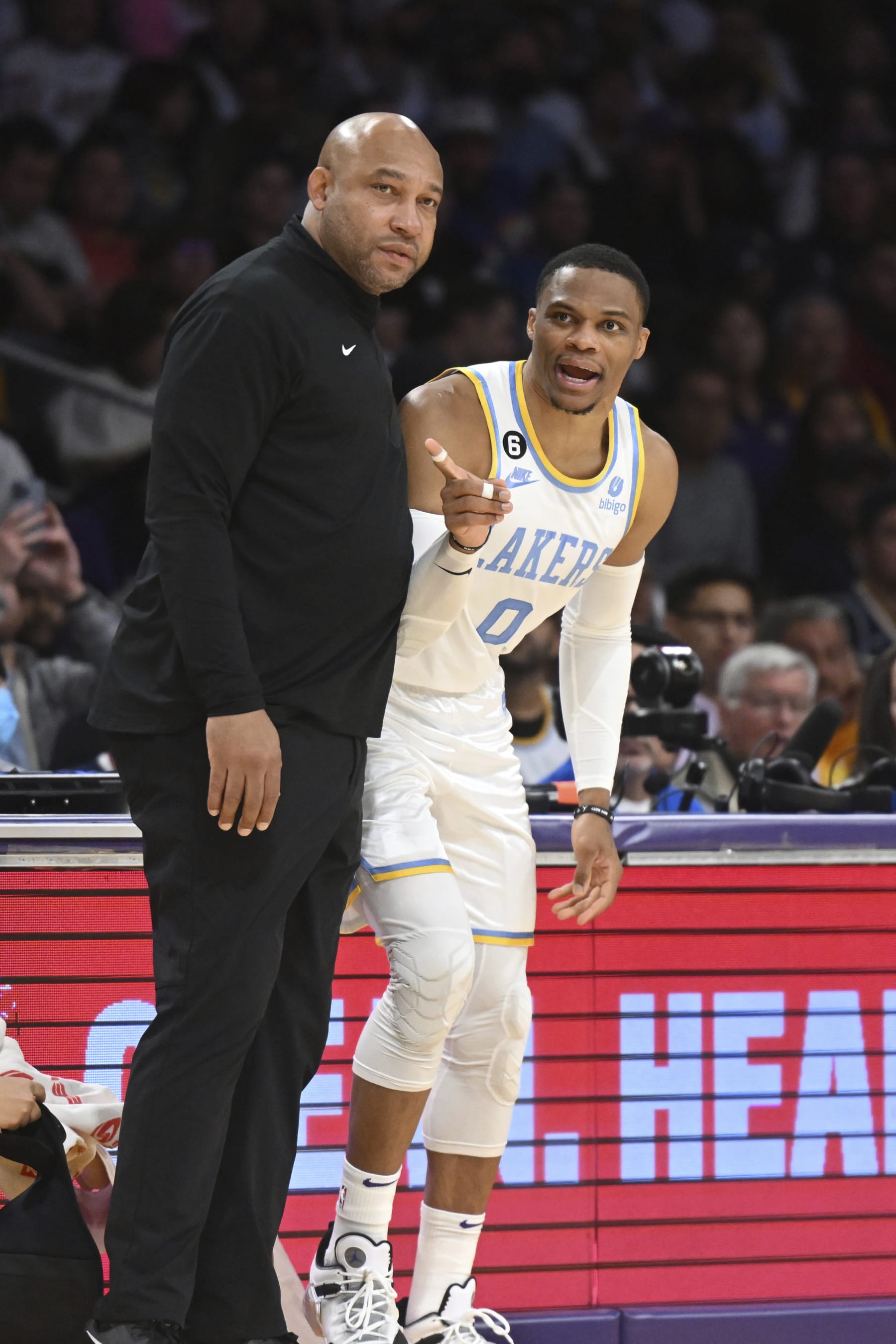 Los Angeles Lakers head coach Darvin Ham talks with guard Russell Westbrook (0) during an NBA basketball game against the Denver Nuggets Sunday, Oct. 30, 2022, in Los Angeles. (AP Photo/Michael Owen Baker)