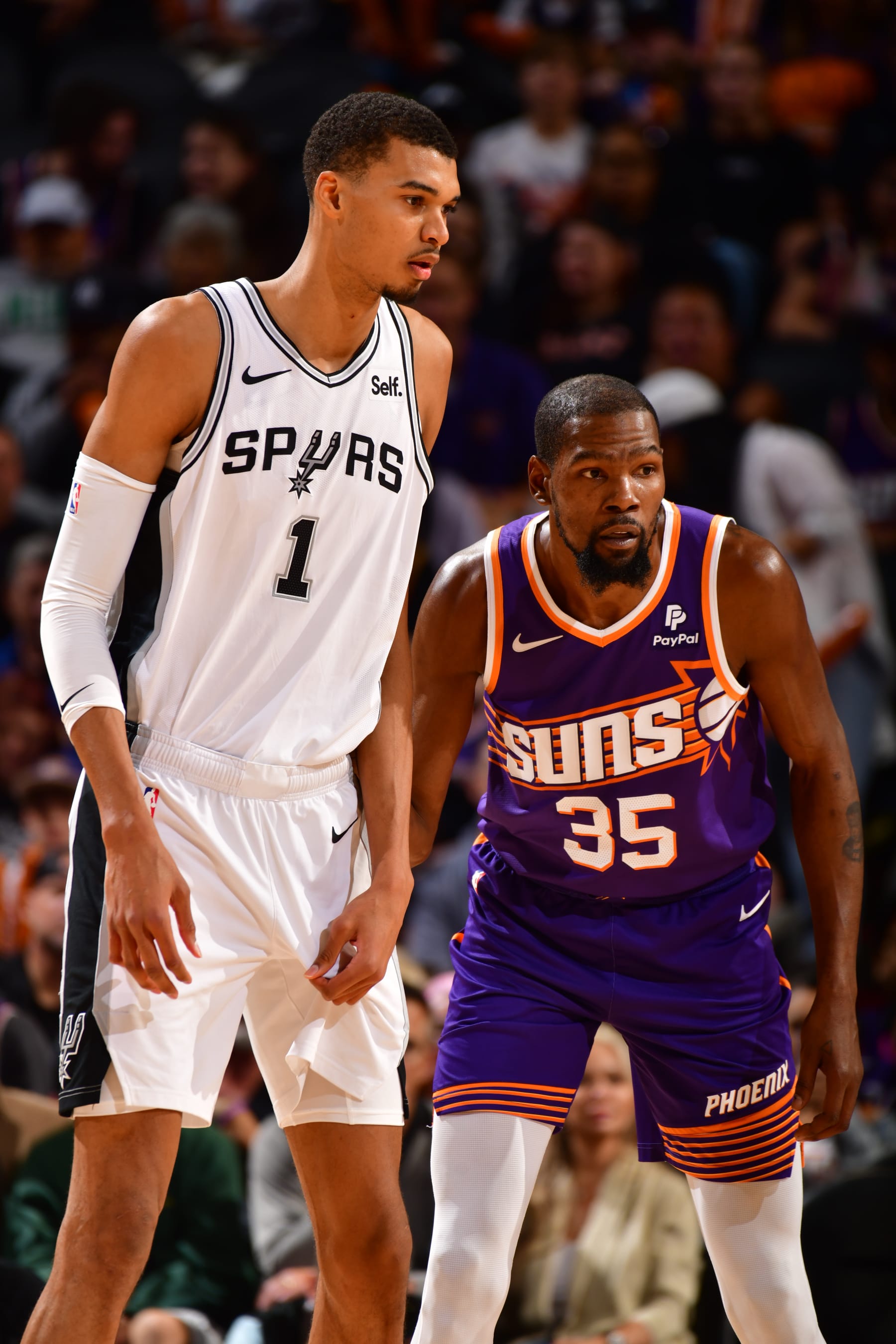 PHOENIX, AZ - NOVEMBER 2: Victor Wembanyama #1 of the San Antonio Spurs and Kevin Durant #35 of the Phoenix Suns looks on during the game on November 2, 2023 at Footprint Center in Phoenix, Arizona. NOTE TO USER: User expressly acknowledges and agrees that, by downloading and or using this photograph, user is consenting to the terms and conditions of the Getty Images License Agreement. Mandatory Copyright Notice: Copyright 2023 NBAE (Photo by Barry Gossage/NBAE via Getty Images)