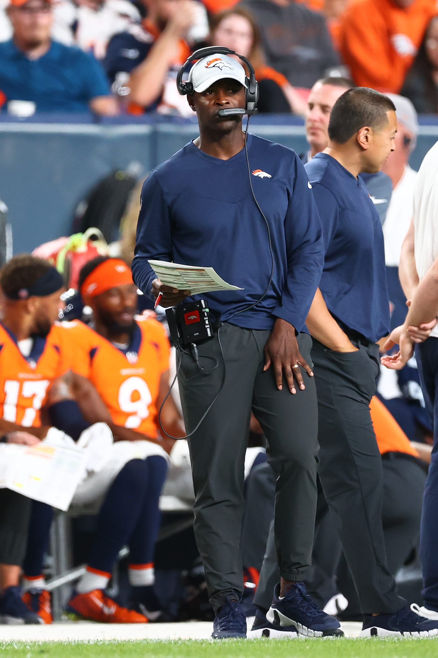 DENVER, CO - AUGUST 27: Offensive coordinator Ejiro Evero of the Denver Broncos coaches during the second half of a preseason game against the Minnesota Vikings at Empower Field At Mile High on August 27, 2022 in Denver, Colorado. (Photo by Justin Tafoya/Getty Images)