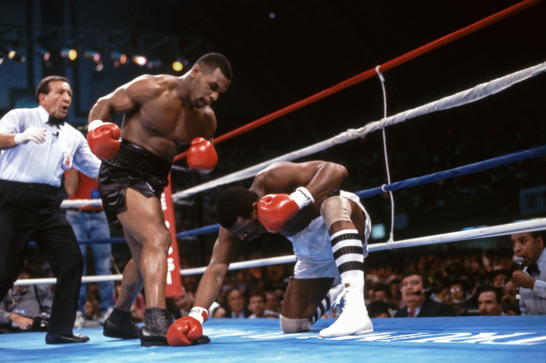 Boxing: WBC/ WBA/ IBF Heavyweight Title: Mike Tyson (L) in action, making round 1 knockdown of Michael Spinks at Boardwalk Convention Hall. View of referee Frank Cappuccino. 
Atlantic City, NJ 6/27/1988
CREDIT: Neil Leifer (Photo by Neil Leifer /Sports Illustrated/Getty Images)
(Set Number: T1001 TK1 R1 F22 )