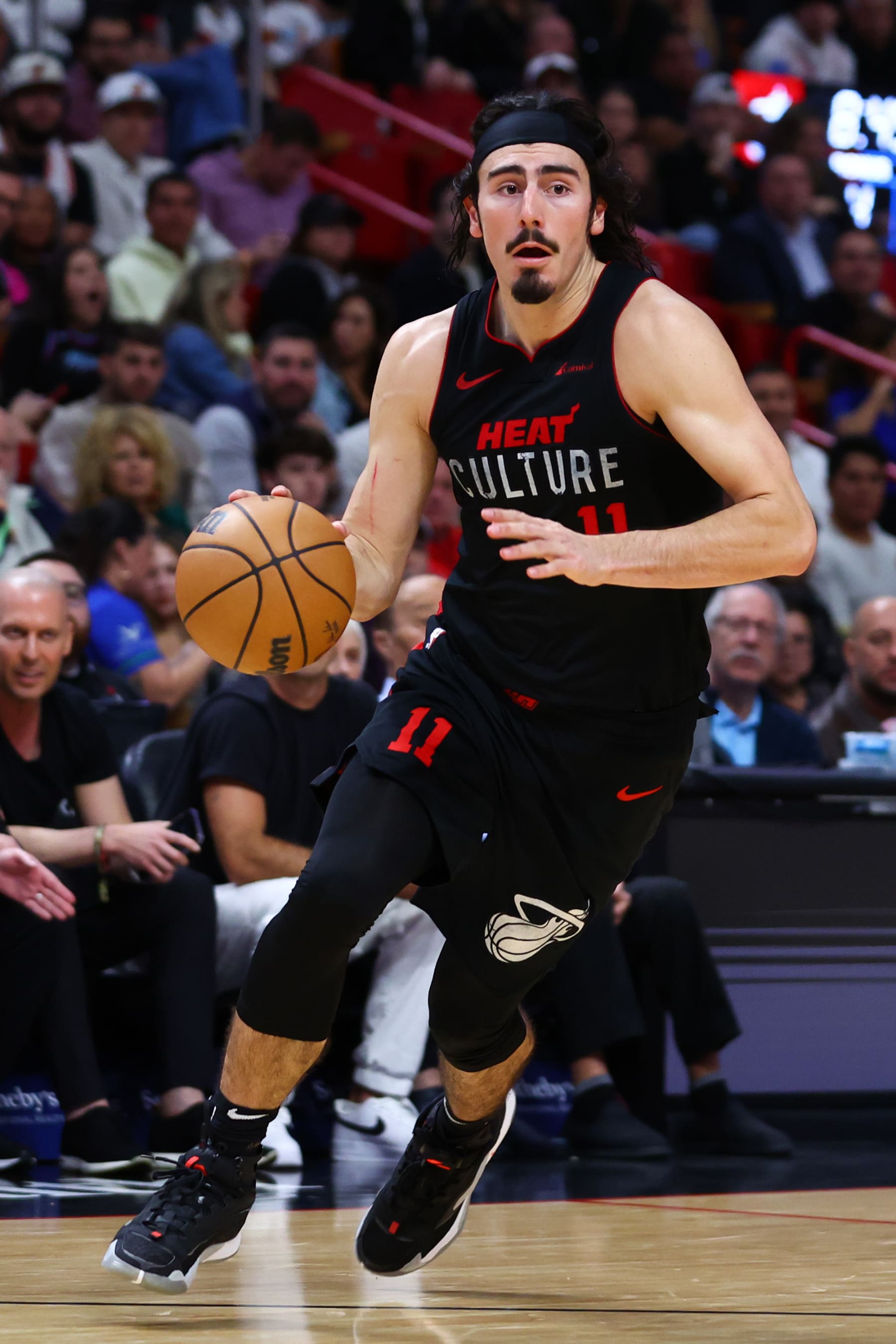 MIAMI, FLORIDA - DECEMBER 18: Jaime Jaquez Jr. #11 of the Miami Heat dribbles the ball against the Minnesota Timberwolves during the fourth quarter at Kaseya Center on December 18, 2023 in Miami, Florida. NOTE TO USER: User expressly acknowledges and agrees that, by downloading and or using this photograph, User is consenting to the terms and conditions of the Getty Images License Agreement. (Photo by Megan Briggs/Getty Images)