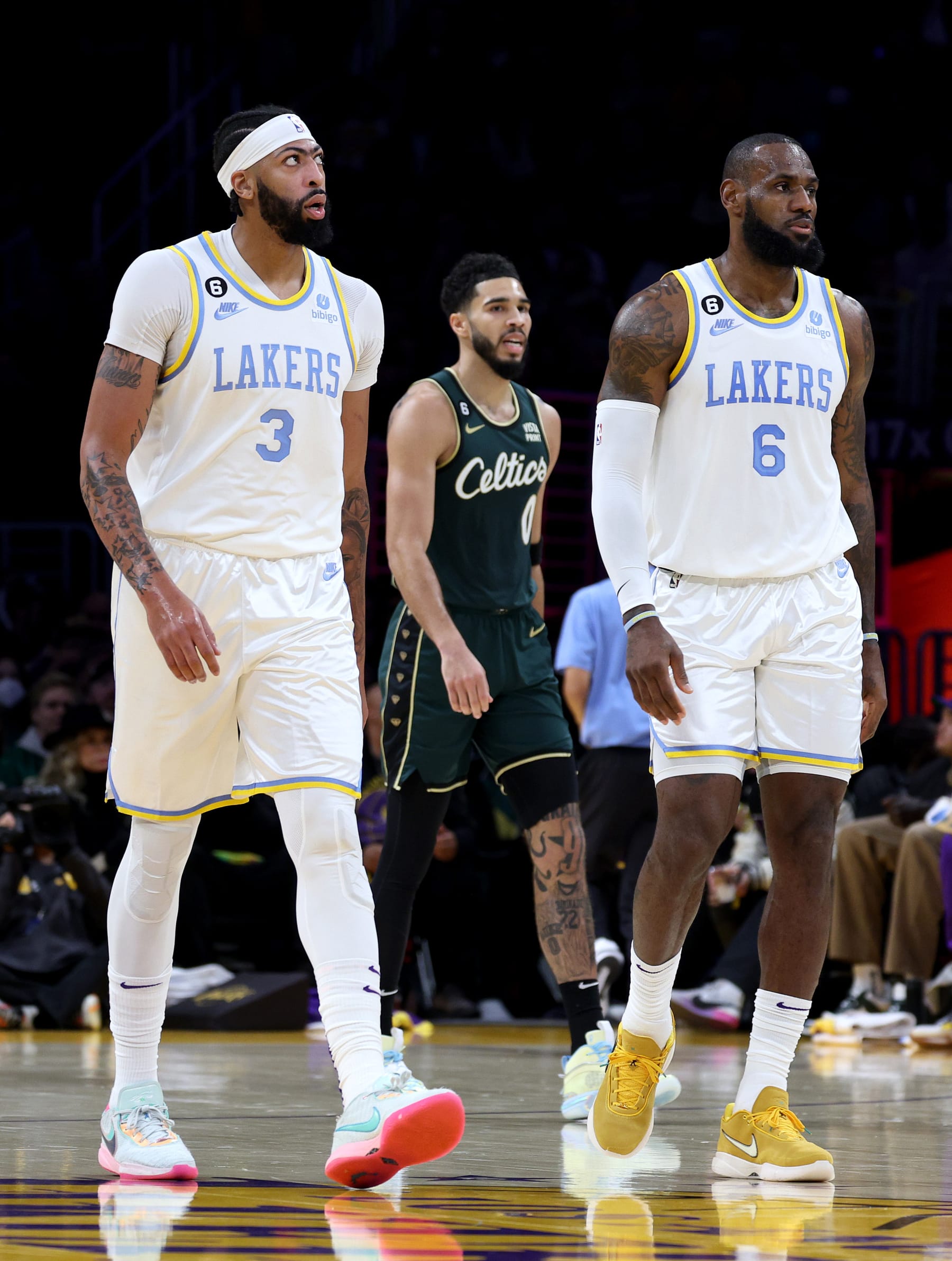 LOS ANGELES, CALIFORNIA - DECEMBER 13: Anthony Davis #3 and LeBron James #6 of the Los Angeles Lakers react after a timeout in front of Jayson Tatum #0 of the Boston Celtics during a 122-118 Celtics overtime win at Crypto.com Arena on December 13, 2022 in Los Angeles, California. NOTE TO USER: User expressly acknowledges and agrees that, by downloading and/or using this photograph, User is consenting to the terms and conditions of the Getty Images License Agreement. Mandatory Copyright Notice: Copyright 2022 NBAE. (Photo by Harry How/Getty Images)