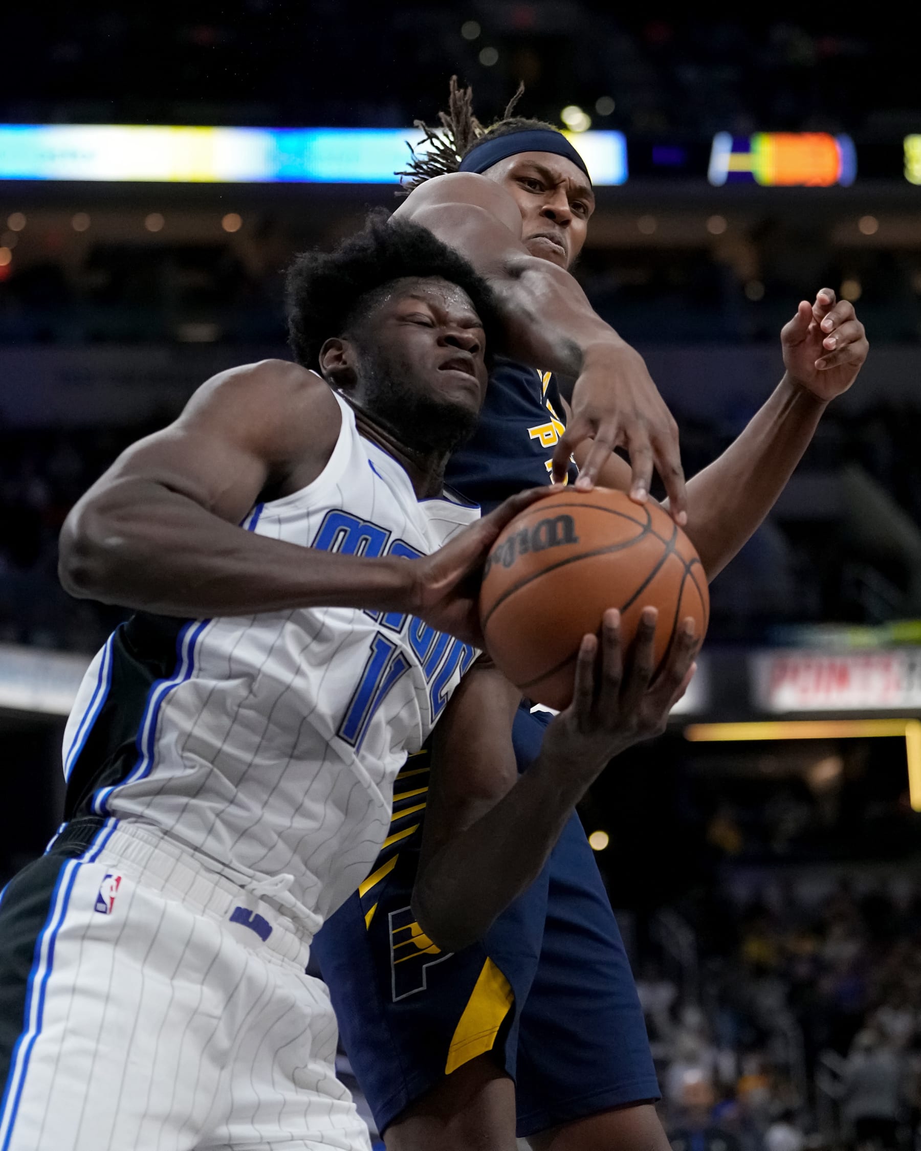 INDIANAPOLIS, INDIANA - NOVEMBER 19: Myles Turner #33 of the Indiana Pacers and Mo Bamba #11 of the Orlando Magic battle for a loose ball in the fourth quarter at Gainbridge Fieldhouse on November 19, 2022 in Indianapolis, Indiana. NOTE TO USER: User expressly acknowledges and agrees that, by downloading and or using this photograph, User is consenting to the terms and conditions of the Getty Images License Agreement. (Photo by Dylan Buell/Getty Images)