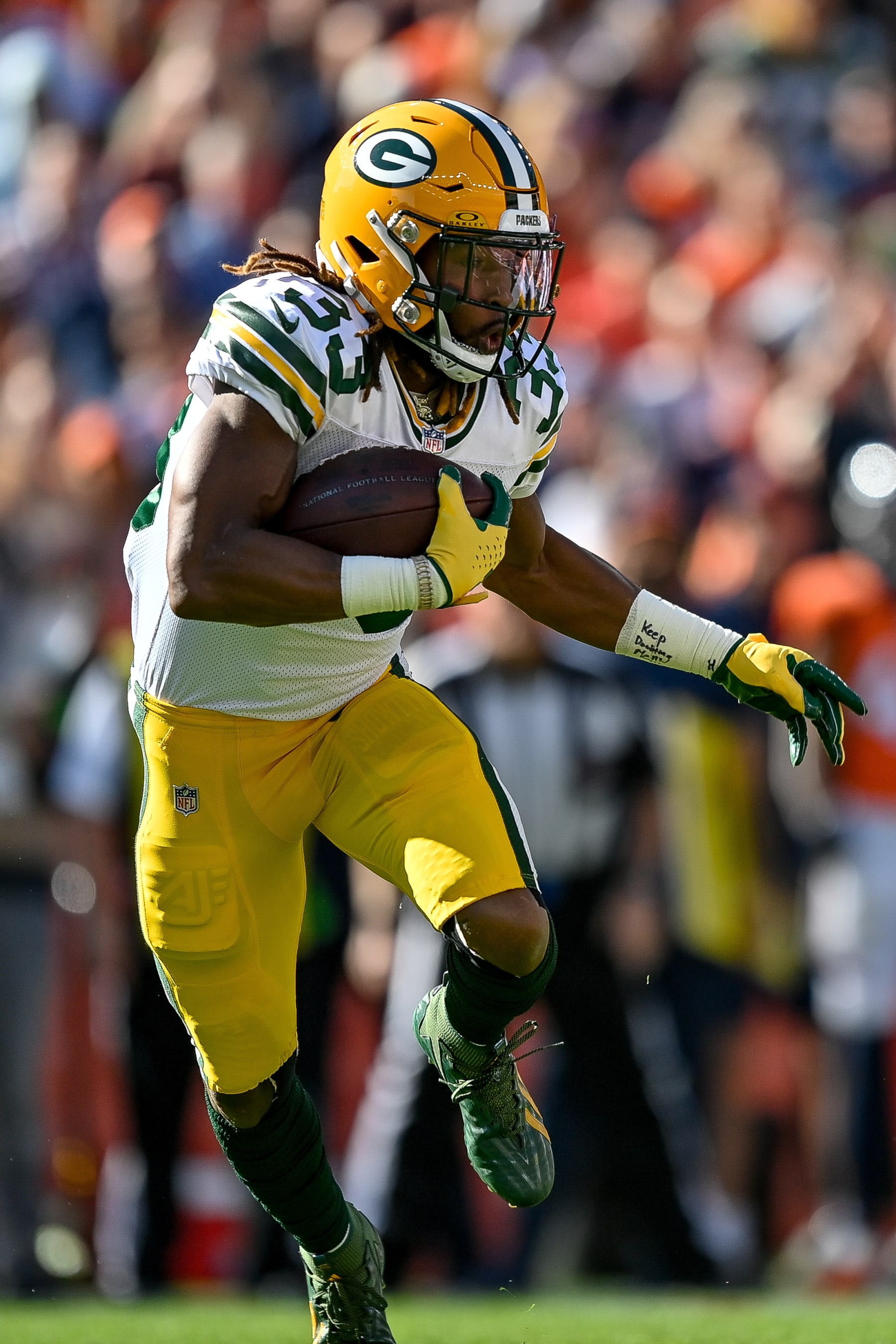 DENVER, COLORADO - OCTOBER 22:  Running back Aaron Jones #33 carries the ball against the Denver Broncos in the first quarter at Empower Field at Mile High on October 22, 2023 in Denver, Colorado. (Photo by Dustin Bradford/Getty Images)