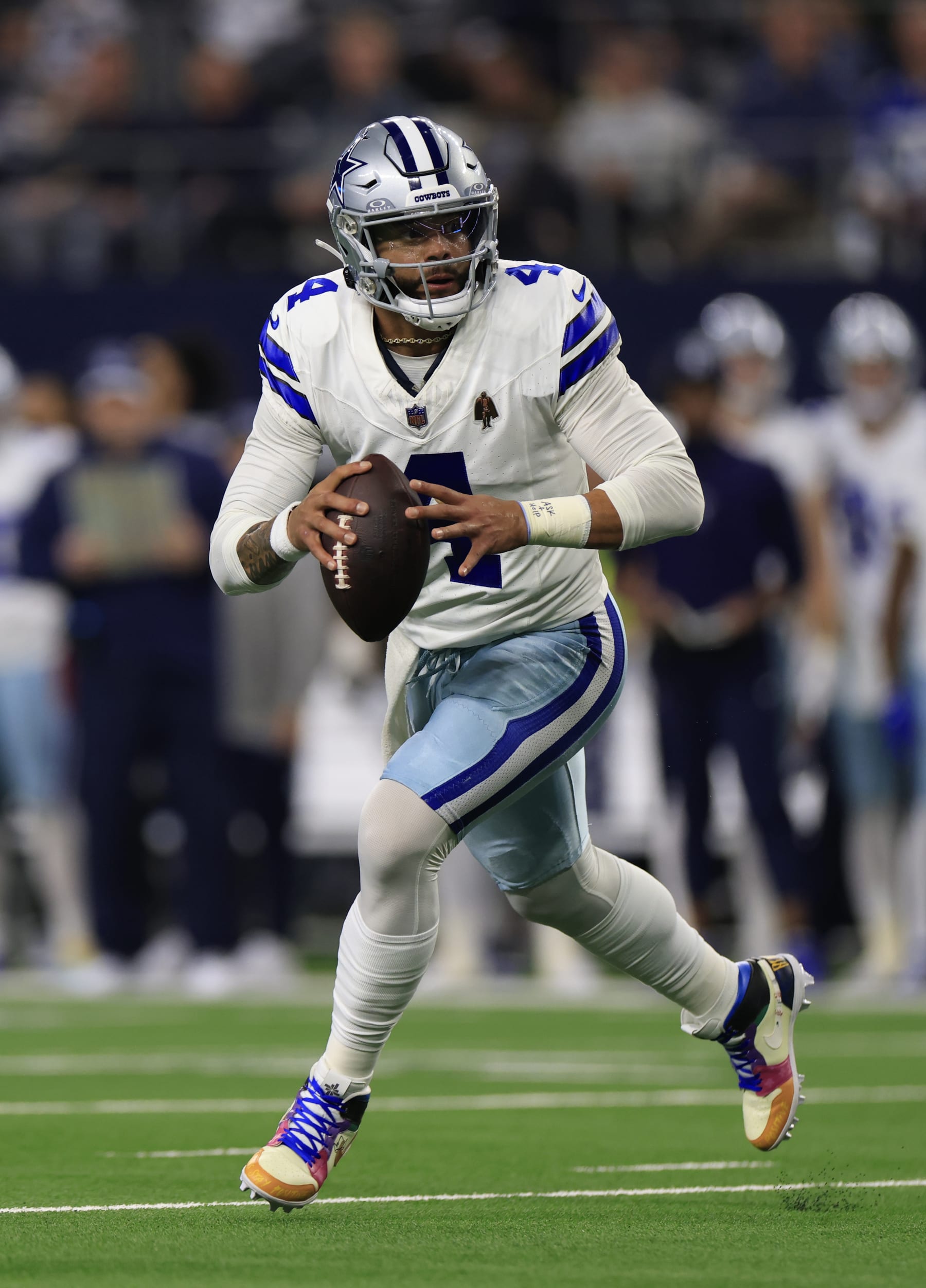 ARLINGTON, TEXAS - NOVEMBER 30: Quarterback Dak Prescott #4 of the Dallas Cowboys scrambles during the first quarter of the game against the Seattle Seahawks at AT&T Stadium on November 30, 2023 in Arlington, Texas. (Photo by Ron Jenkins/Getty Images)