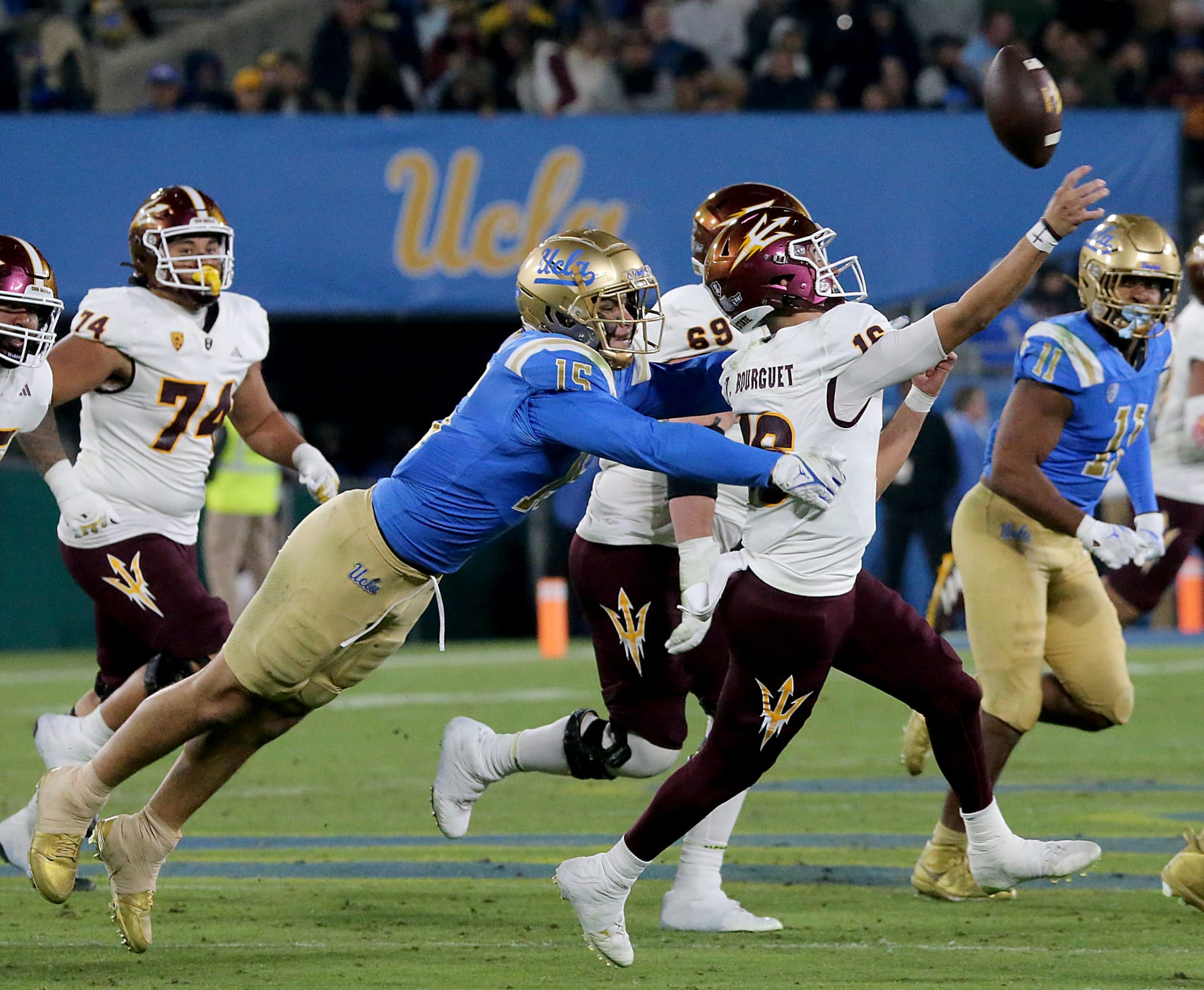 Pasadena, CA -  UCLA edge rusher Laiatu Latu pressures ASU quarterback Trenton Bourguet in the second half of a Pac-12 Conference football game at the Rose Bowl in Pasadena on Saturday night, Nov. 11, 2023. (Luis Sinco / Los Angeles Times via Getty Images)