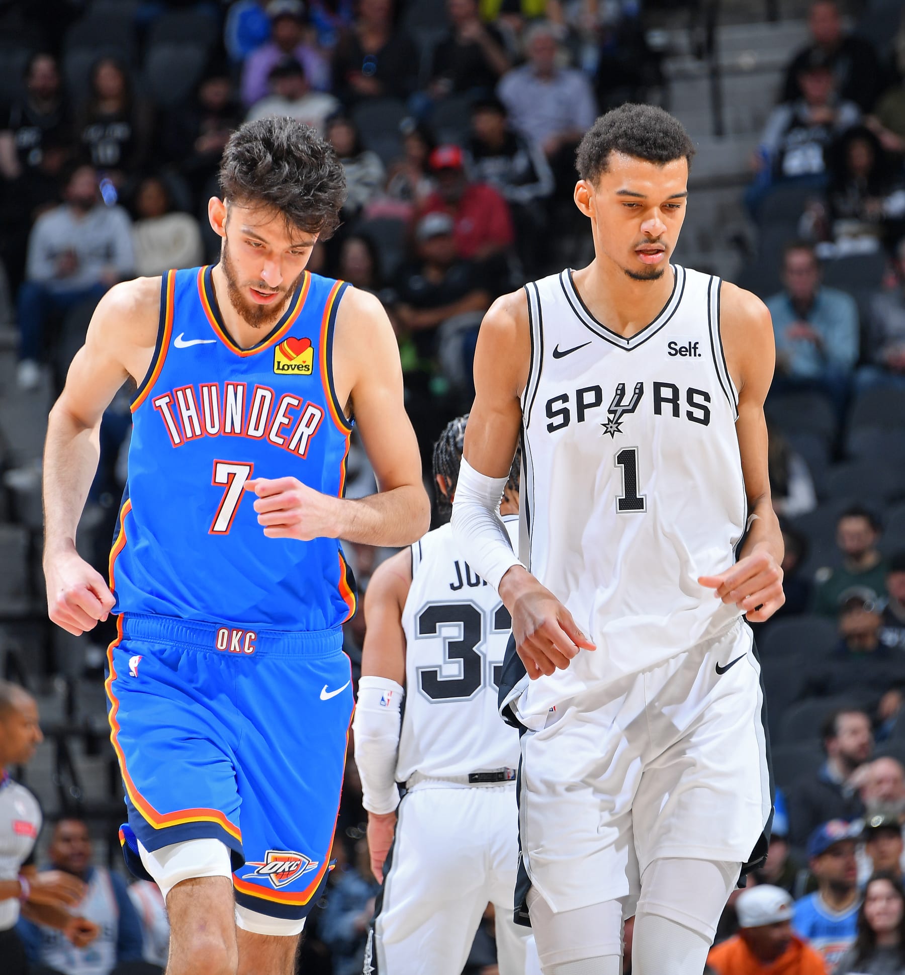 SAN ANTONIO, TX - FEBRUARY 29: Chet Holmgren #7 of the Oklahoma City Thunder and Victor Wembanyama #1 of the San Antonio Spurs looks on during the game on February 29, 2024 at the Frost Bank Center in San Antonio, Texas. NOTE TO USER: User expressly acknowledges and agrees that, by downloading and or using this photograph, user is consenting to the terms and conditions of the Getty Images License Agreement. Mandatory Copyright Notice: Copyright 2024 NBAE (Photos by Michael Gonzales/NBAE via Getty Images)