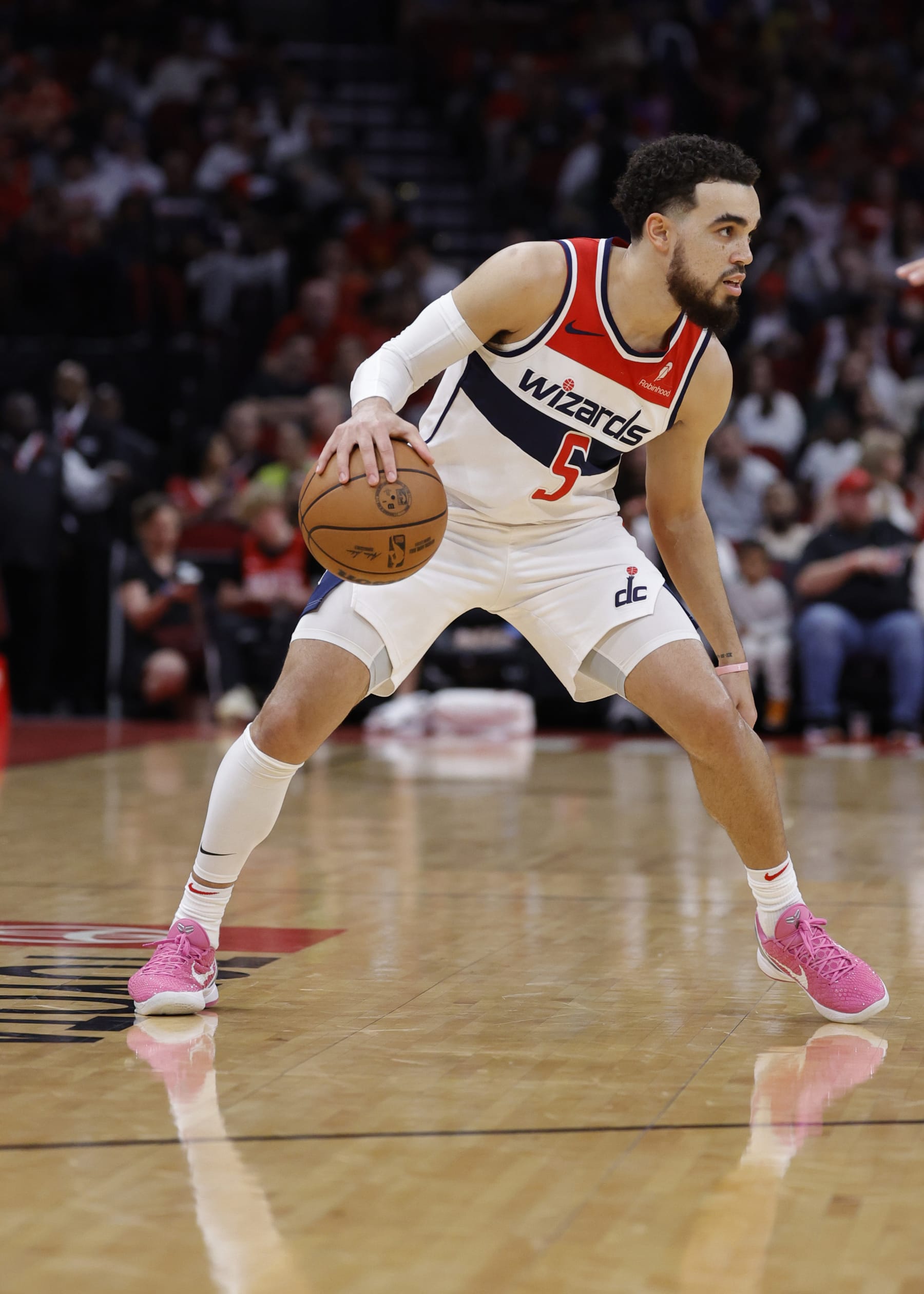 HOUSTON, TEXAS - MARCH 14: Tyus Jones #5 of the Washington Wizards controls the ball against the Houston Rockets during the first half at Toyota Center on March 14, 2024 in Houston, Texas. NOTE TO USER: User expressly acknowledges and agrees that, by downloading and or using this photograph, User is consenting to the terms and conditions of the Getty Images License Agreement.  (Photo by Carmen Mandato/Getty Images)