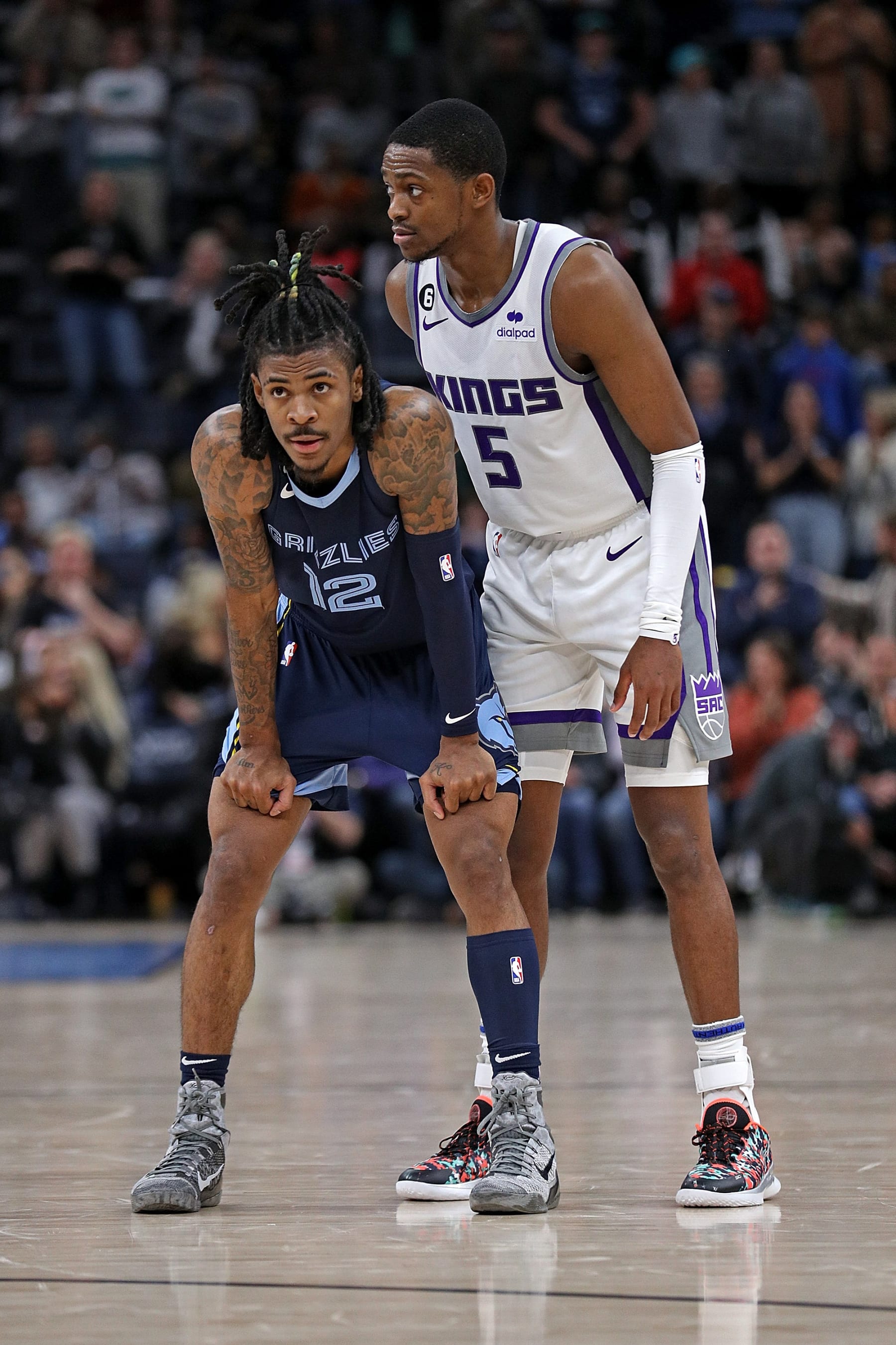 MEMPHIS, TENNESSEE - NOVEMBER 22: Ja Morant #12 of the Memphis Grizzlies and De'Aaron Fox #5 of the Sacramento Kings during the game at FedExForum on November 22, 2022 in Memphis, Tennessee. NOTE TO USER: User expressly acknowledges and agrees that, by downloading and or using this photograph, User is consenting to the terms and conditions of the Getty Images License Agreement. (Photo by Justin Ford/Getty Images)