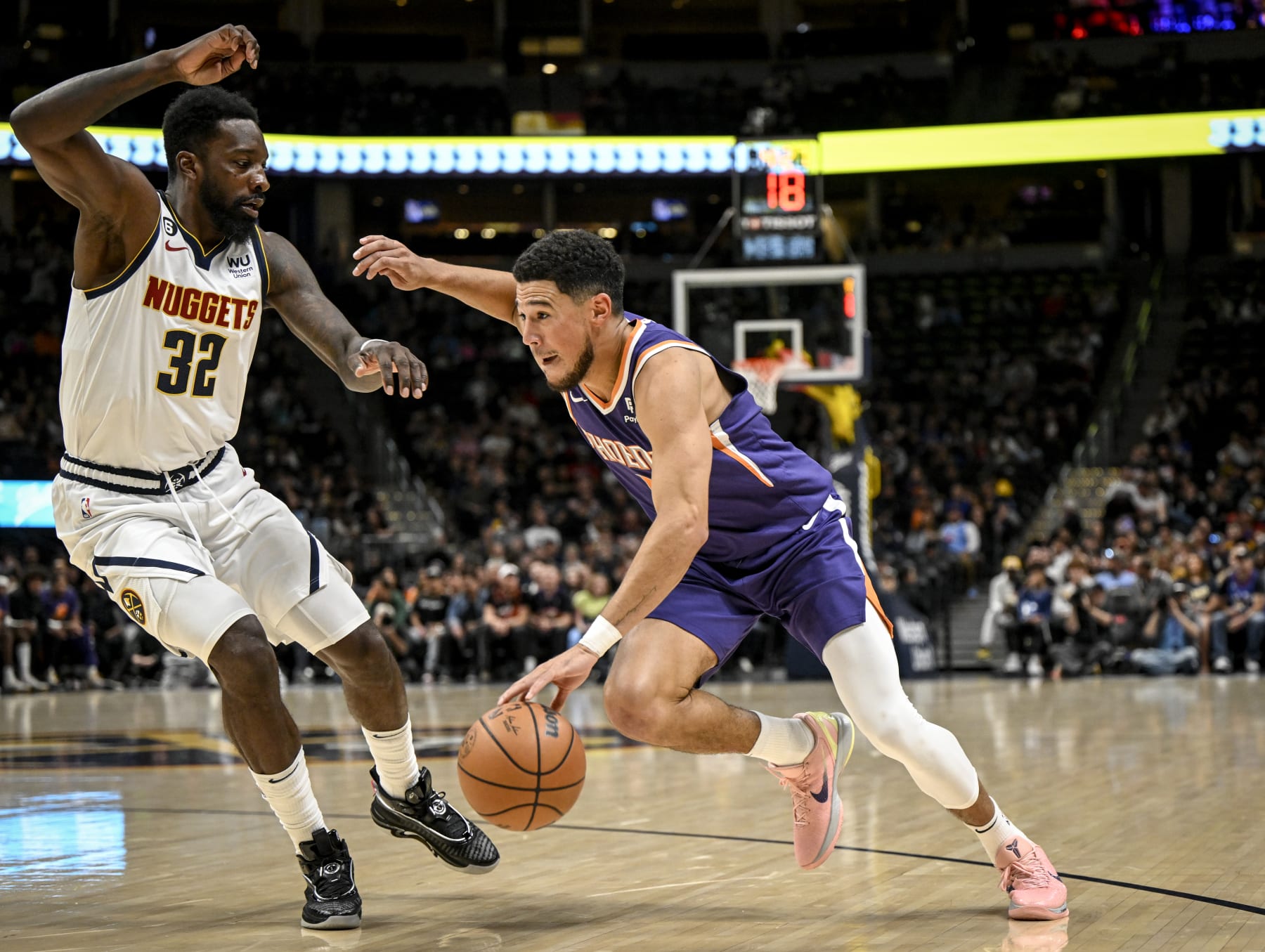 DENVER, CO - OCTOBER 10: Devin Booker (1) of the Phoenix Suns drives on Jeff Green (32) of the Denver Nuggets during the first quarter on Monday, October 10, 2022. (Photo by AAron Ontiveroz/MediaNews Group/The Denver Post via Getty Images)