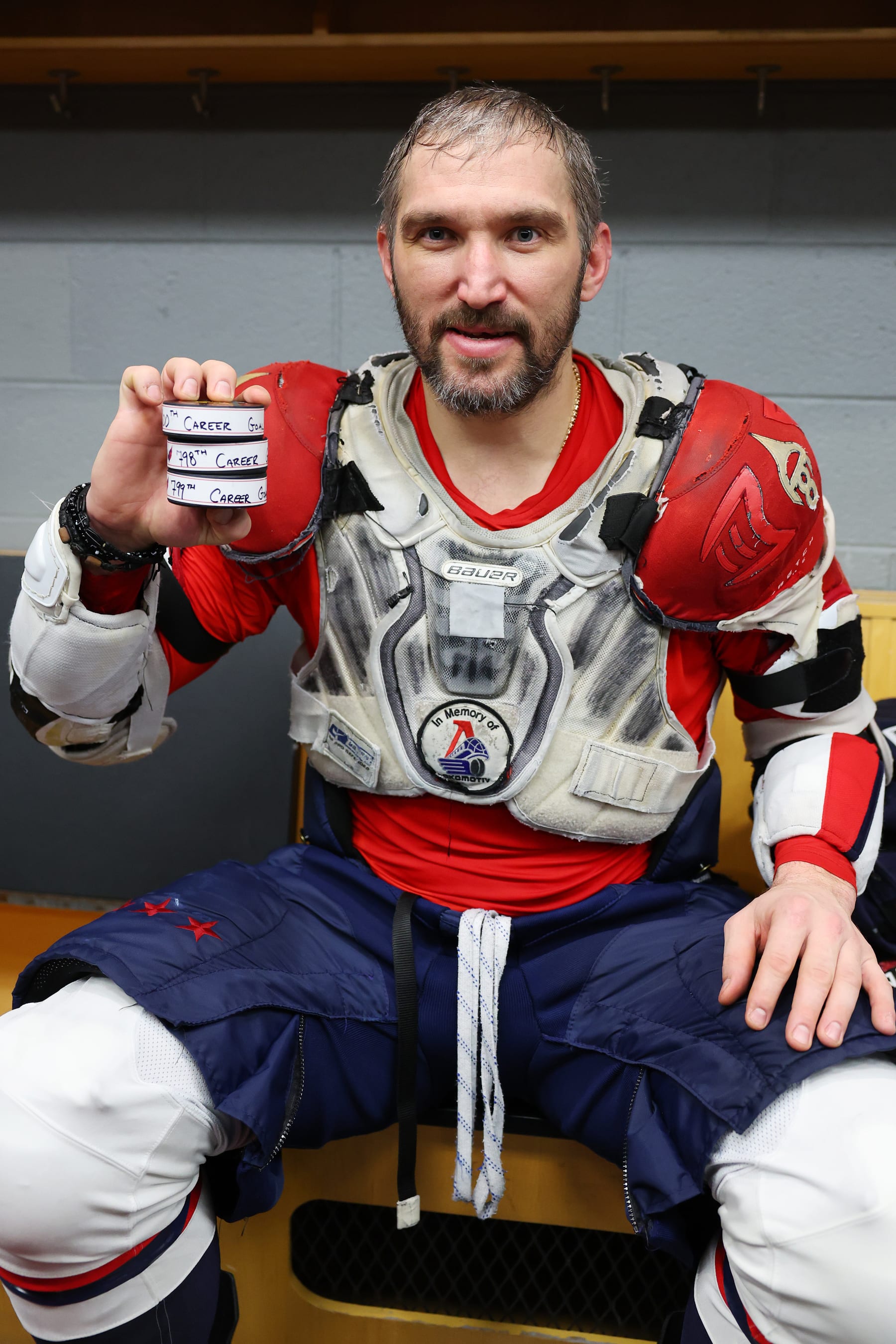 CHICAGO, ILLINOIS - DECEMBER 13: Alex Ovechkin #8 of the Washington Capitals poses with the pucks from his 798th, 799th and 800th career goal after the game at United Center on December 13, 2022 in Chicago, Illinois. (Photo by Michael Reaves/Getty Images)