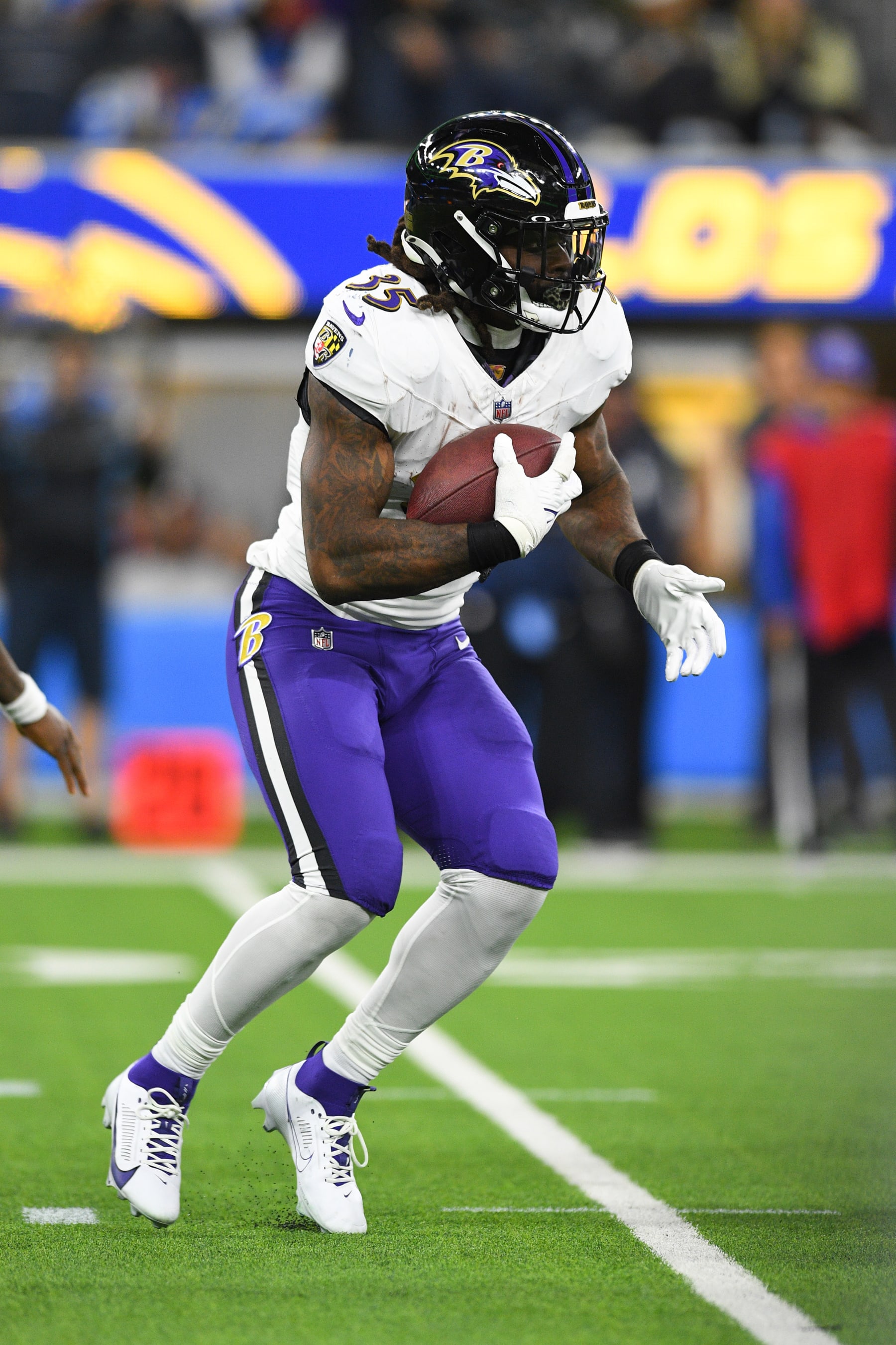 INGLEWOOD, CA - NOVEMBER 26: Baltimore Ravens running back Gus Edwards (35) runs the ball during the NFL regular season game between the Baltimore Ravens and the Los Angeles Chargers on November 26, 2023, at SoFi Stadium in Inglewood, CA. (Photo by Brian Rothmuller/Icon Sportswire via Getty Images)