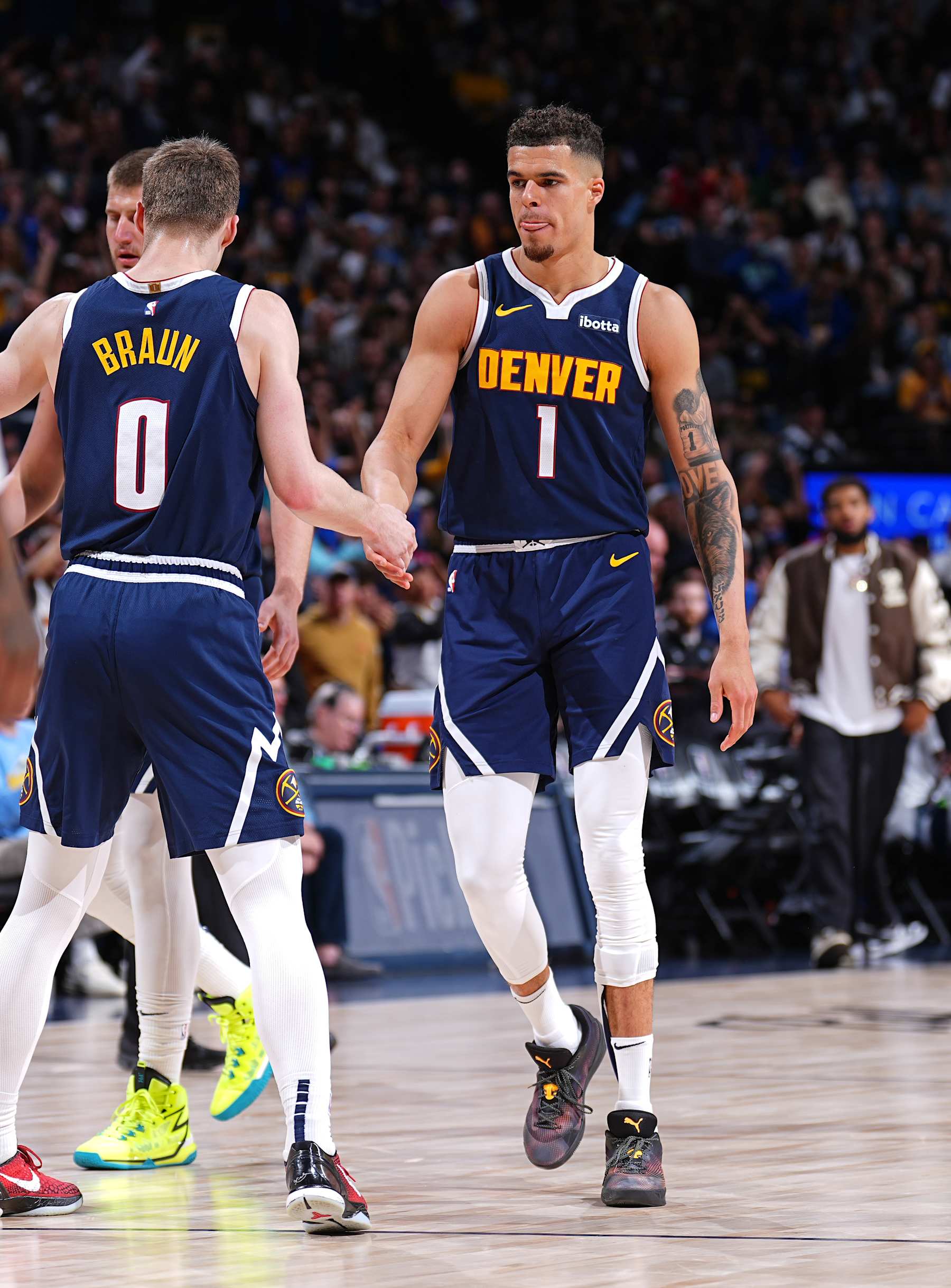 DENVER, CO - APRIL 10: Christian Braun #0 and Michael Porter Jr. #1 of the Denver Nuggets high five during the game against the Minnesota Timberwolves on April 10, 2024 at the Ball Arena in Denver, Colorado. NOTE TO USER: User expressly acknowledges and agrees that, by downloading and/or using this Photograph, user is consenting to the terms and conditions of the Getty Images License Agreement. Mandatory Copyright Notice: Copyright 2024 NBAE (Photo by Garrett Ellwood/NBAE via Getty Images)