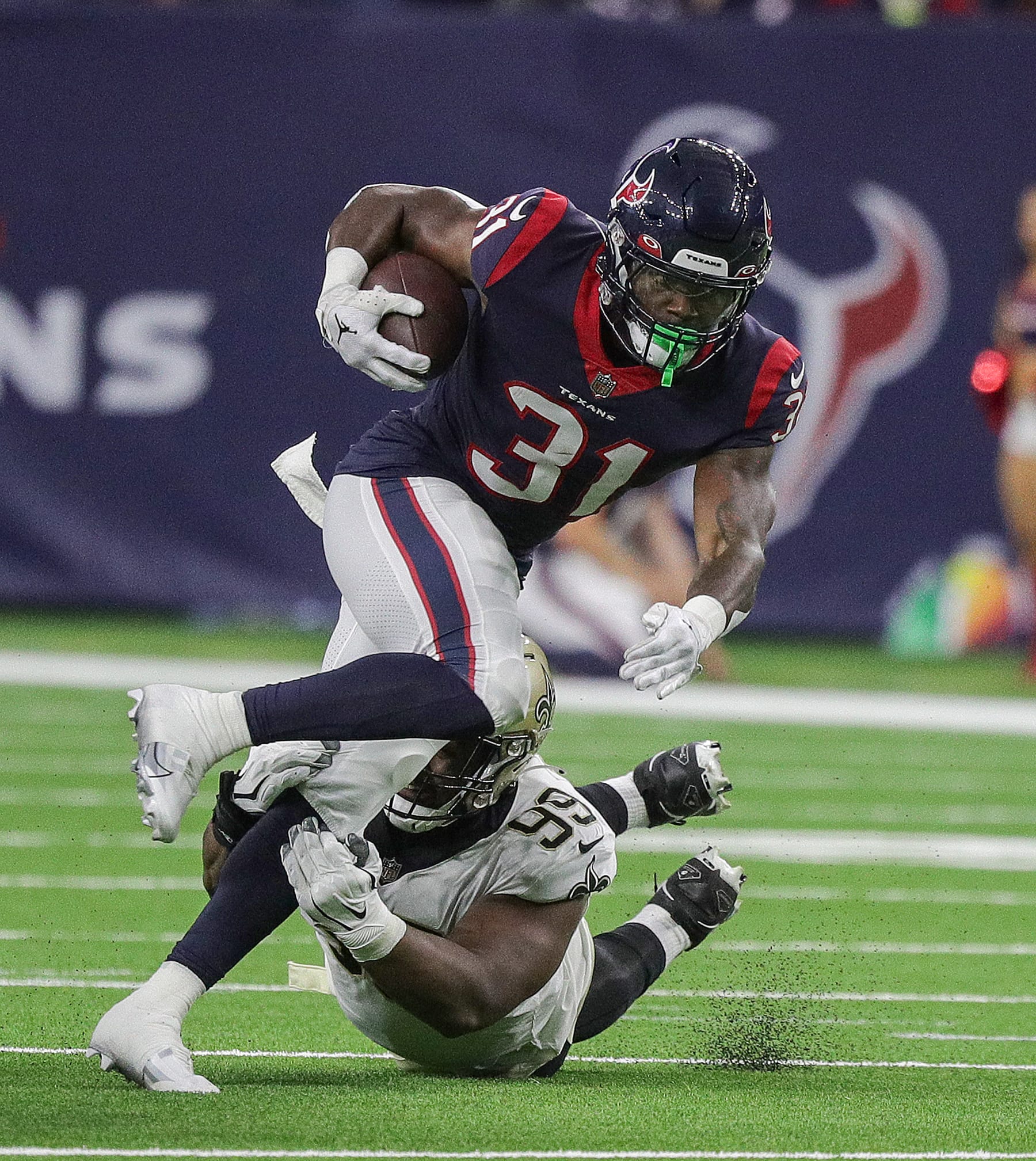 HOUSTON, TEXAS - AUGUST 13: Dameon Pierce #31 of the Houston Texans breaks a tackle attempt by Shy Tuttle #99 of the New Orleans Saints in the first half in a preseason game at NRG Stadium on August 13, 2022 in Houston, Texas. (Photo by Bob Levey/Getty Images)