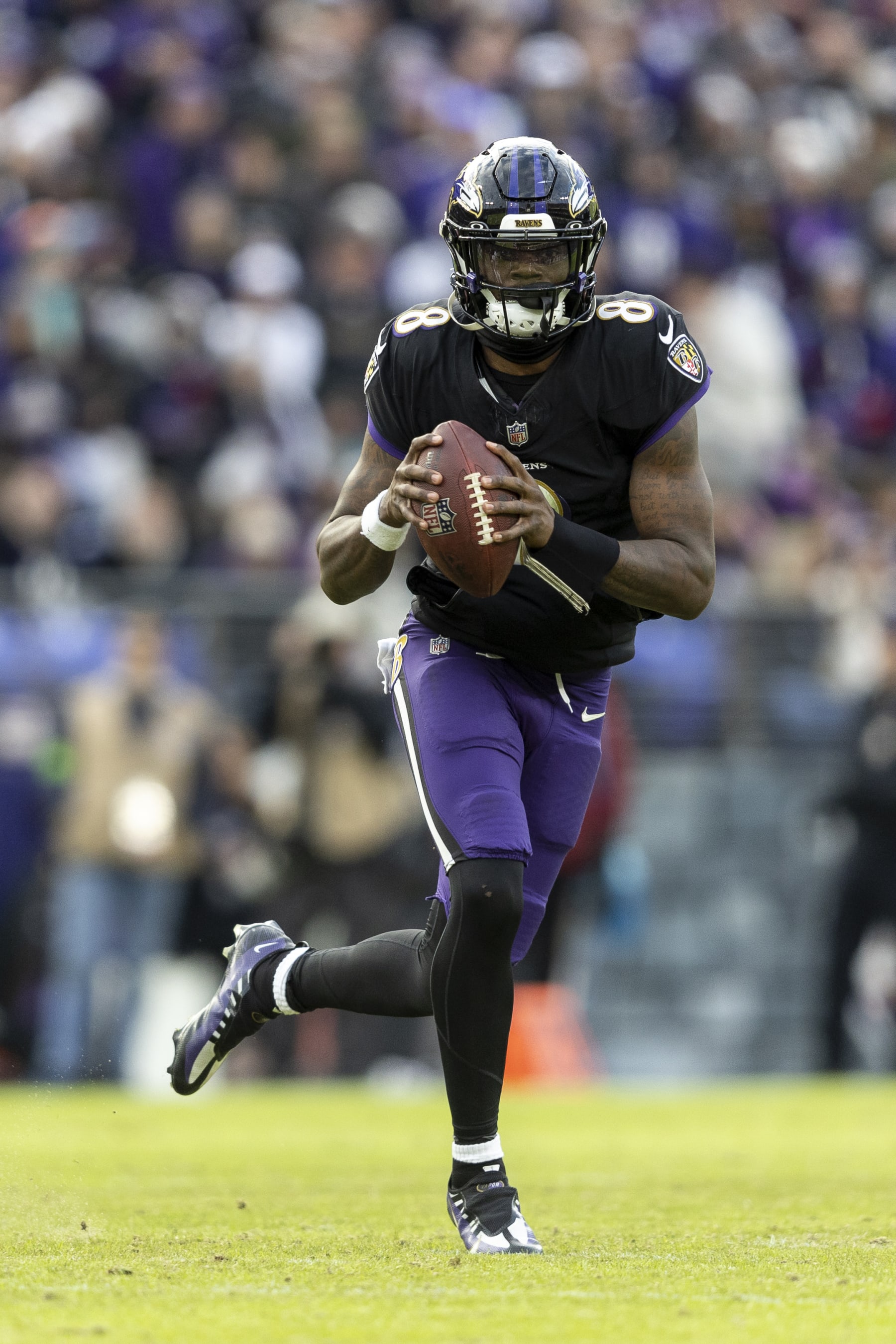 BALTIMORE, MARYLAND - DECEMBER 31: Lamar Jackson #8 of the Baltimore Ravens runs with the ball and looks to pass during an NFL football game between the Baltimore Ravens and the Miami Dolphins at M&T Bank Stadium on December 31, 2023 in Baltimore, Maryland. (Photo by Michael Owens/Getty Images)