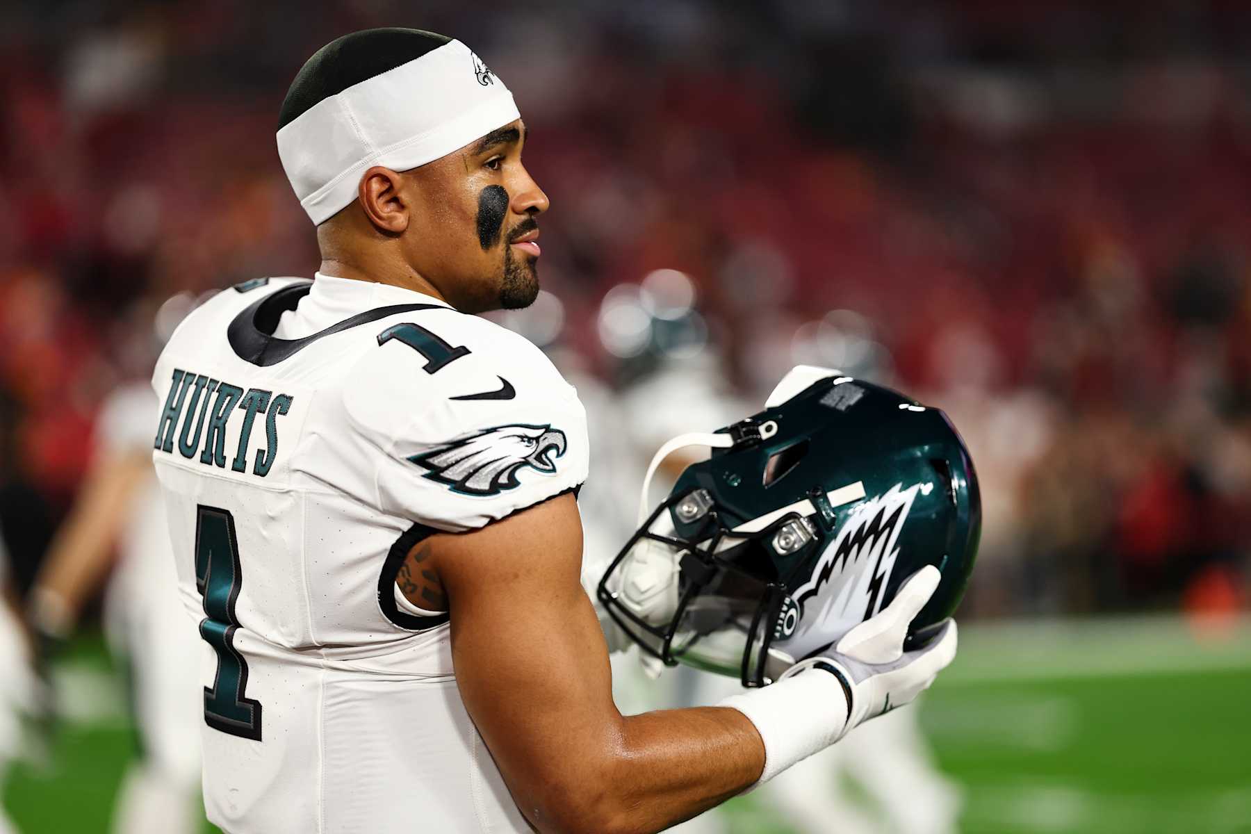 TAMPA, FL - JANUARY 15: Jalen Hurts #1 of the Philadelphia Eagles puts on his helmet prior to an NFL wild-card playoff football game against the Tampa Bay Buccaneers at Raymond James Stadium on January 15, 2024 in Tampa, Florida. (Photo by Kevin Sabitus/Getty Images)