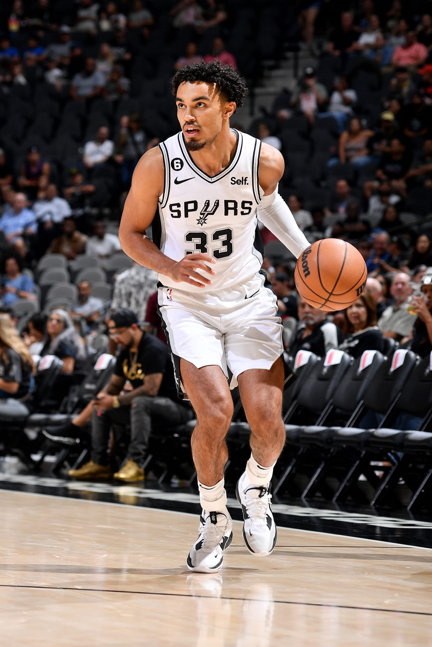 SAN ANTONIO, TX - OCTOBER 13: Tre Jones #33 of the San Antonio Spurs dribbles the ball against the Oklahoma City Thunder  during a preseason game on October 13, 2022 at the AT&T Center in San Antonio, Texas. NOTE TO USER: User expressly acknowledges and agrees that, by downloading and or using this photograph, user is consenting to the terms and conditions of the Getty Images License Agreement. Mandatory Copyright Notice: Copyright 2022 NBAE (Photos by Michael Gonzales/NBAE via Getty Images)