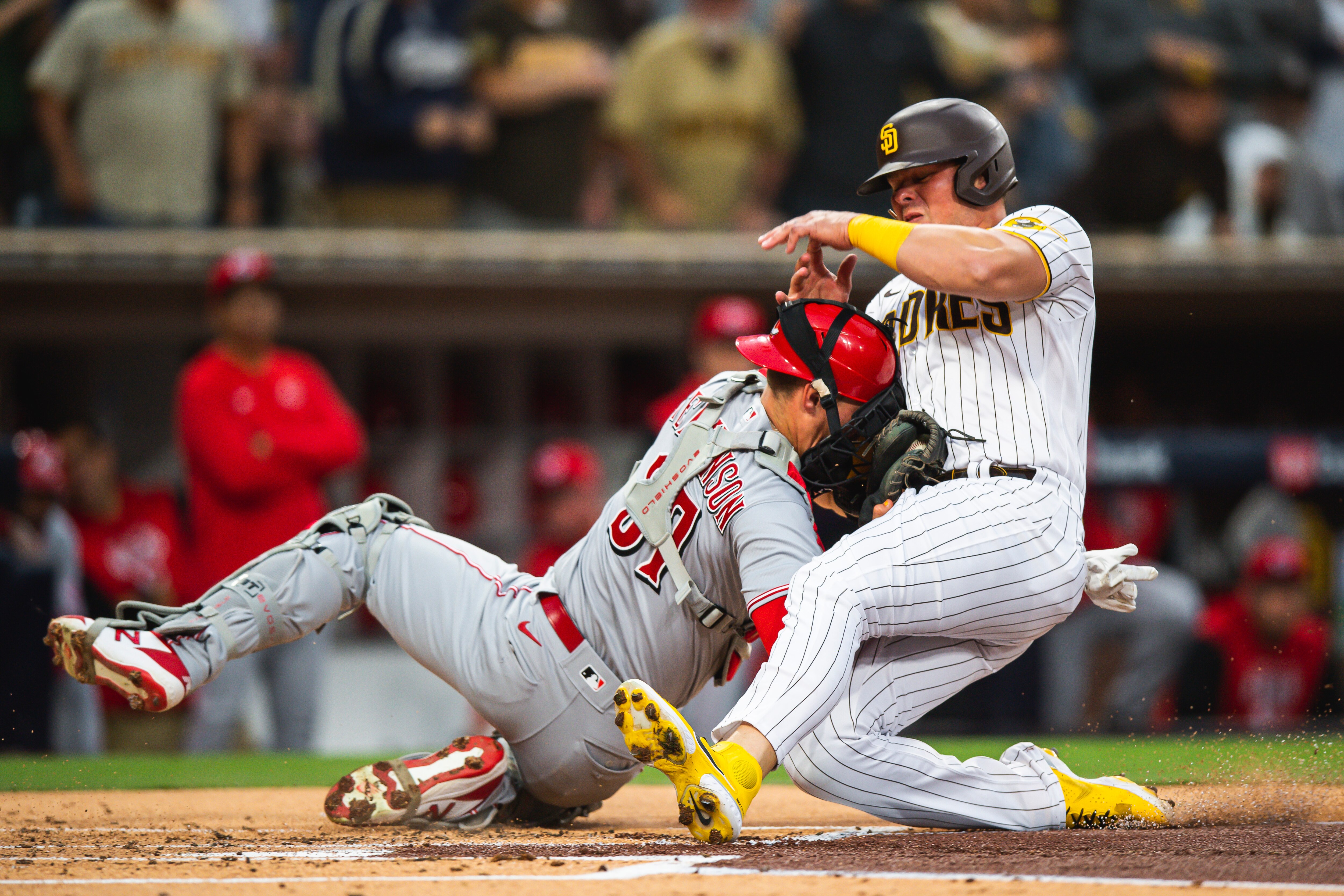 SAN DIEGO, CA - APRIL 19: Luke Voit #45 of the San Diego Padres crashes into Tyler Stephenson #37 of the Cincinnati Reds in the first inning at Petco Park on April 19, 2022 in San Diego, California. (Photo by Matt Thomas/San Diego Padres/Getty Images)