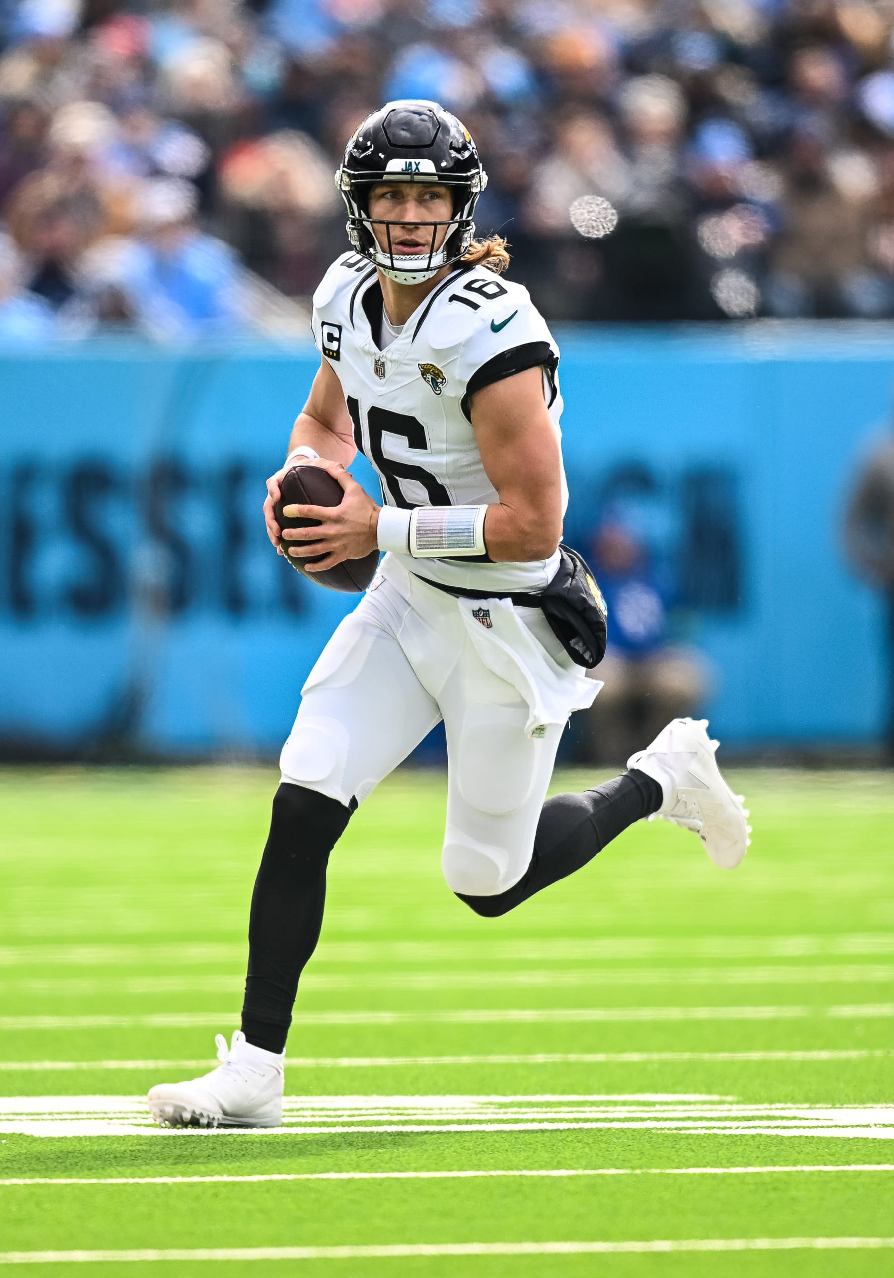 NASHVILLE, TN - JANUARY 07: Jacksonville Jaguars quarterback Trevor Lawrence (16) scrambles out of the pocket during the NFL game between the Tennessee Titans and the Jacksonville Jaguars on January 7, 2024, at Nissan Stadium in Nashville, TN. (Photo by Bryan Lynn/Icon Sportswire via Getty Images)