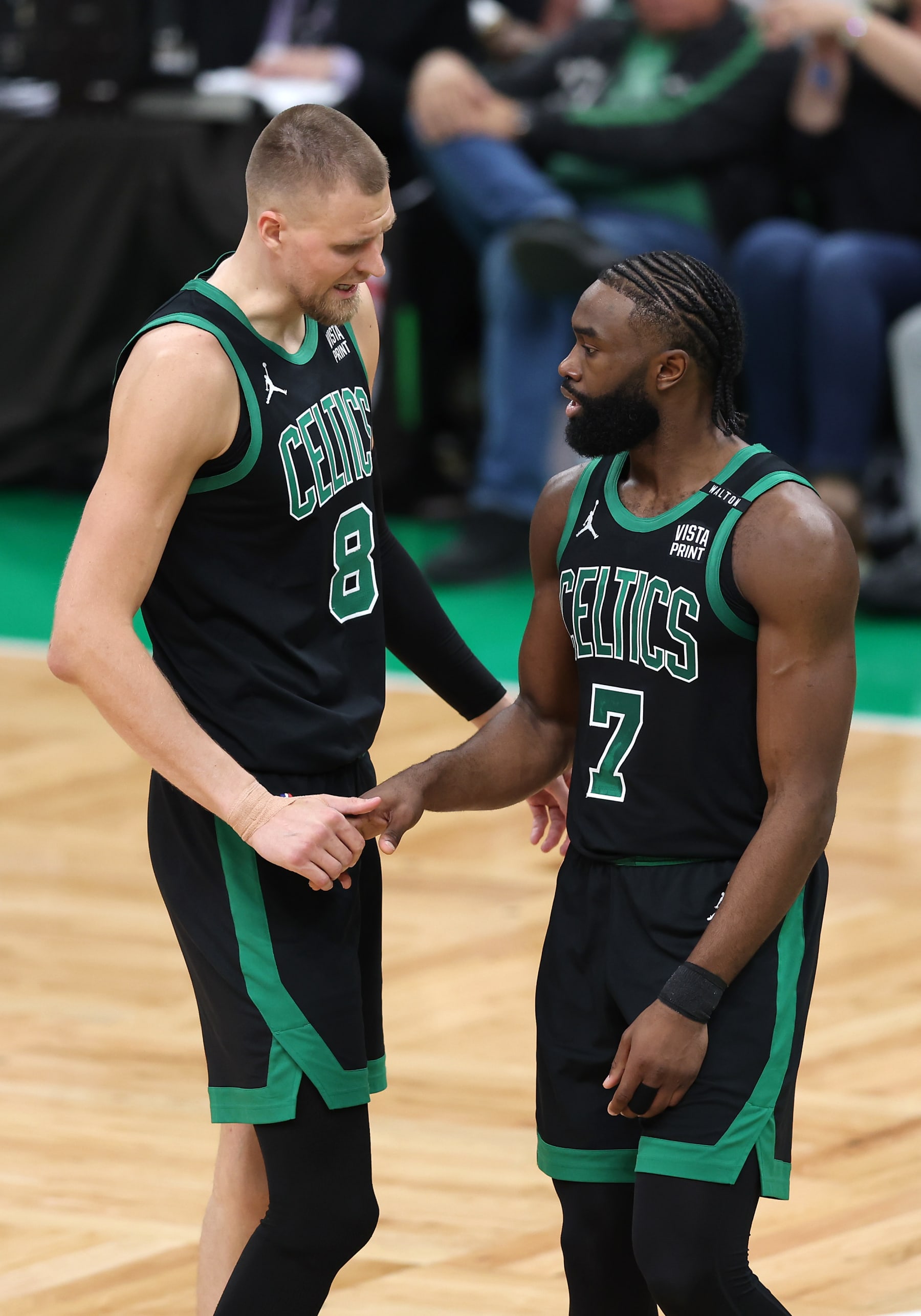 BOSTON, MASSACHUSETTS - JUNE 09: Kristaps Porzingis #8 and Jaylen Brown #7 of the Boston Celtics high five during the second quarter against the Dallas Mavericks in Game Two of the 2024 NBA Finals at TD Garden on June 09, 2024 in Boston, Massachusetts. NOTE TO USER: User expressly acknowledges and agrees that, by downloading and or using this photograph, User is consenting to the terms and conditions of the Getty Images License Agreement. (Photo by Adam Glanzman/Getty Images)