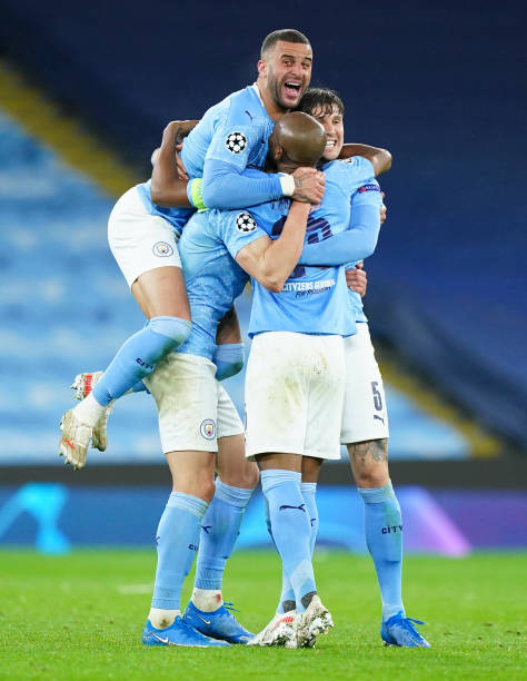 MANCHESTER, ENGLAND - MAY 04: Kyle Walker of Manchester City celebrates victory with Fernandinho, Ruben Dias (obscure) and John Stones after the UEFA Champions League Semi Final Second Leg match between Manchester City and Paris Saint-Germain at Etihad Stadium on May 04, 2021 in Manchester, England. Sporting stadiums around the UK remain under strict restrictions due to the Coronavirus Pandemic as Government social distancing laws prohibit fans inside venues resulting in games being played behind closed doors. (Photo by Matt McNulty - Manchester City/Manchester City FC via Getty Images)