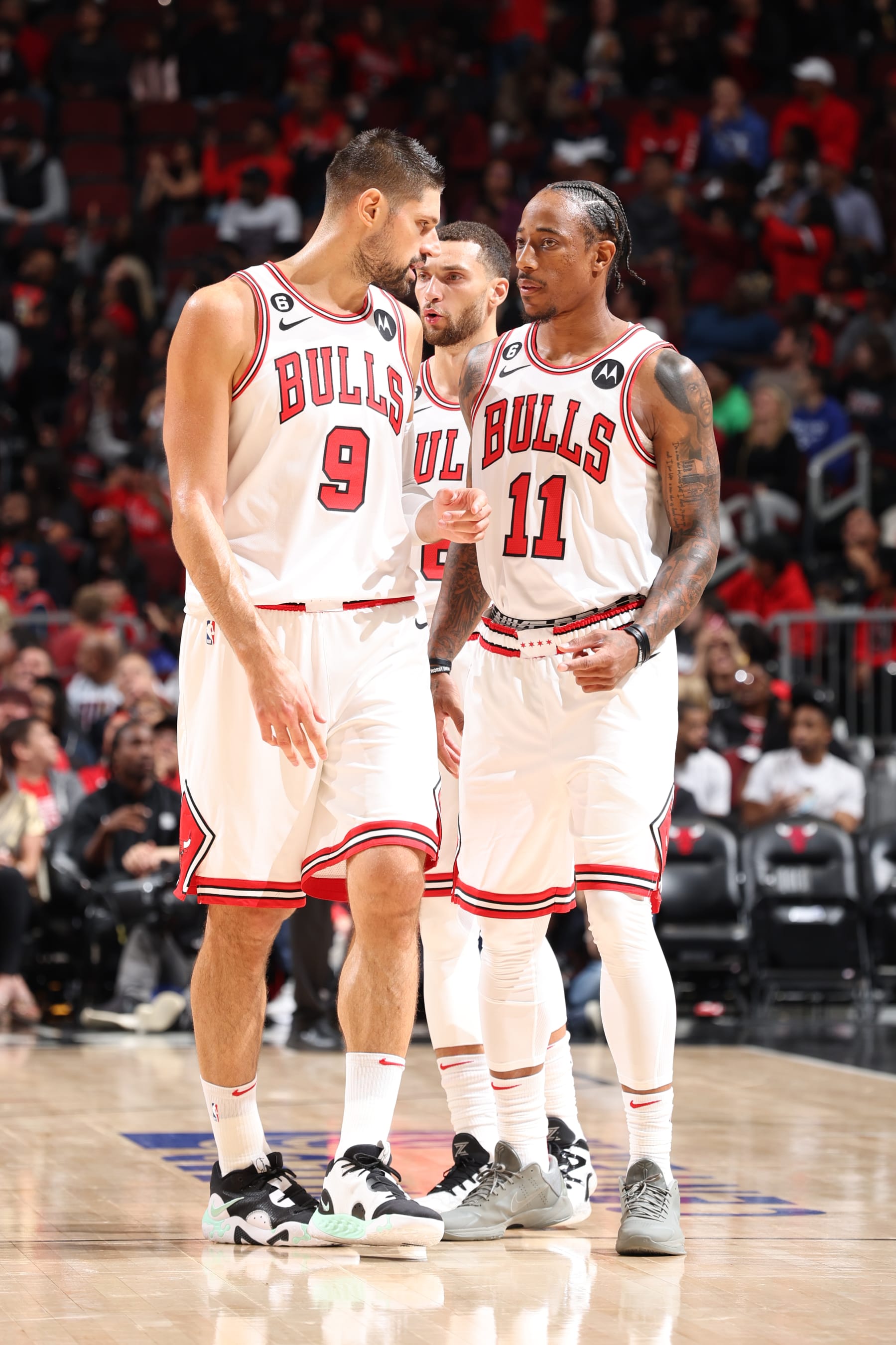 CHICAGO, IL - OCTOBER 4: Nikola Vucevic #9, Zach LaVine #8 and DeMar DeRozan #11 of the Chicago Bulls talk during the game against the New Orleans Pelicans on October 4, 2022 at United Center in Chicago, Illinois. NOTE TO USER: User expressly acknowledges and agrees that, by downloading and or using this photograph, User is consenting to the terms and conditions of the Getty Images License Agreement. Mandatory Copyright Notice: Copyright 2022 NBAE (Photo by Jeff Haynes/NBAE via Getty Images)