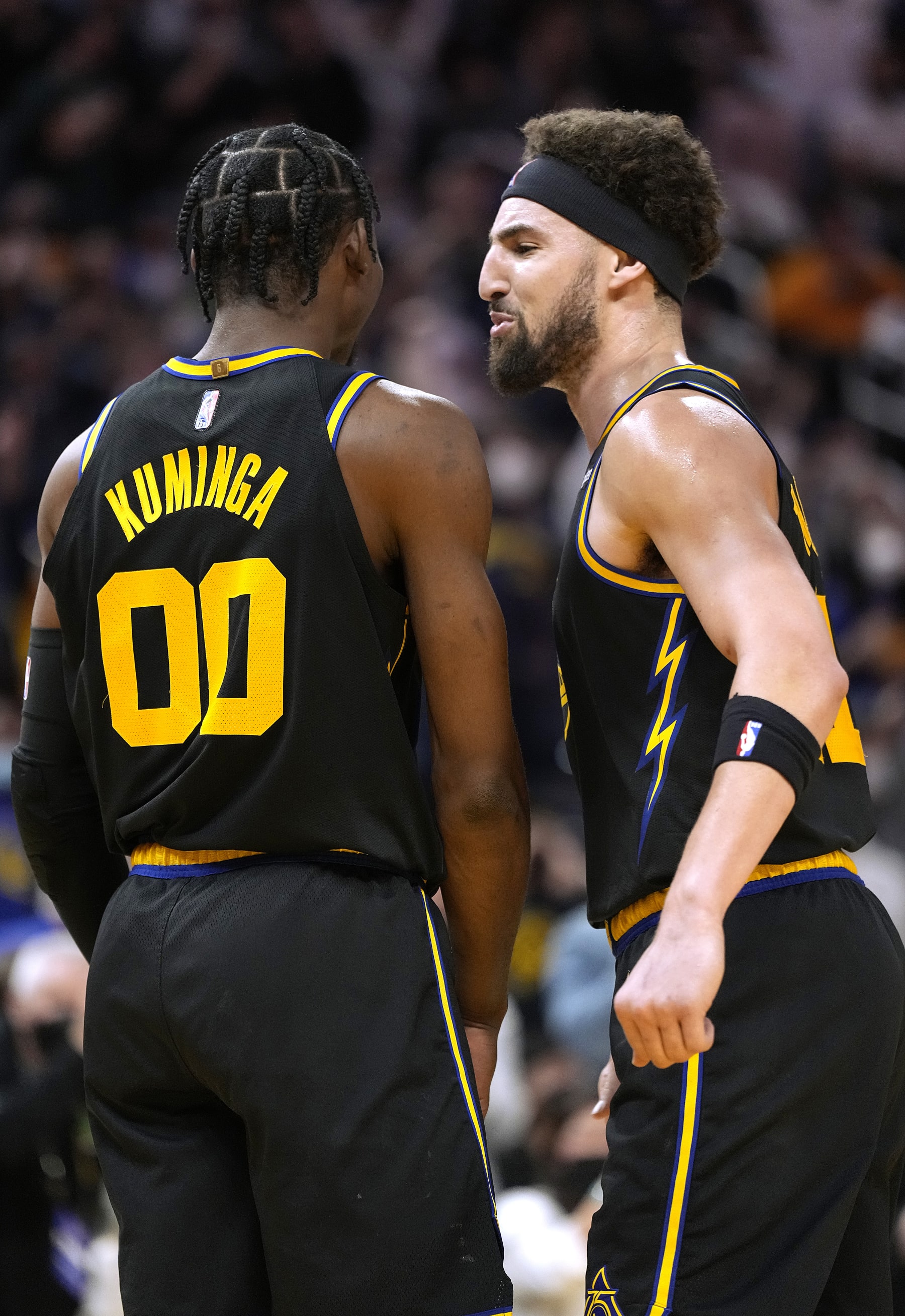 SAN FRANCISCO, CALIFORNIA - JANUARY 25: Jonathan Kuminga #00 and Klay Thompson #11 of the Golden State Warriors celebrates after Kuminga slam dunked and was fouled on the play against the Dallas Mavericks during the second half of an NBA game at Chase Center on January 25, 2022 in San Francisco, California. NOTE TO USER: User expressly acknowledges and agrees that, by downloading and or using this photograph, User is consenting to the terms and conditions of the Getty Images License Agreement. (Photo by Thearon W. Henderson/Getty Images)