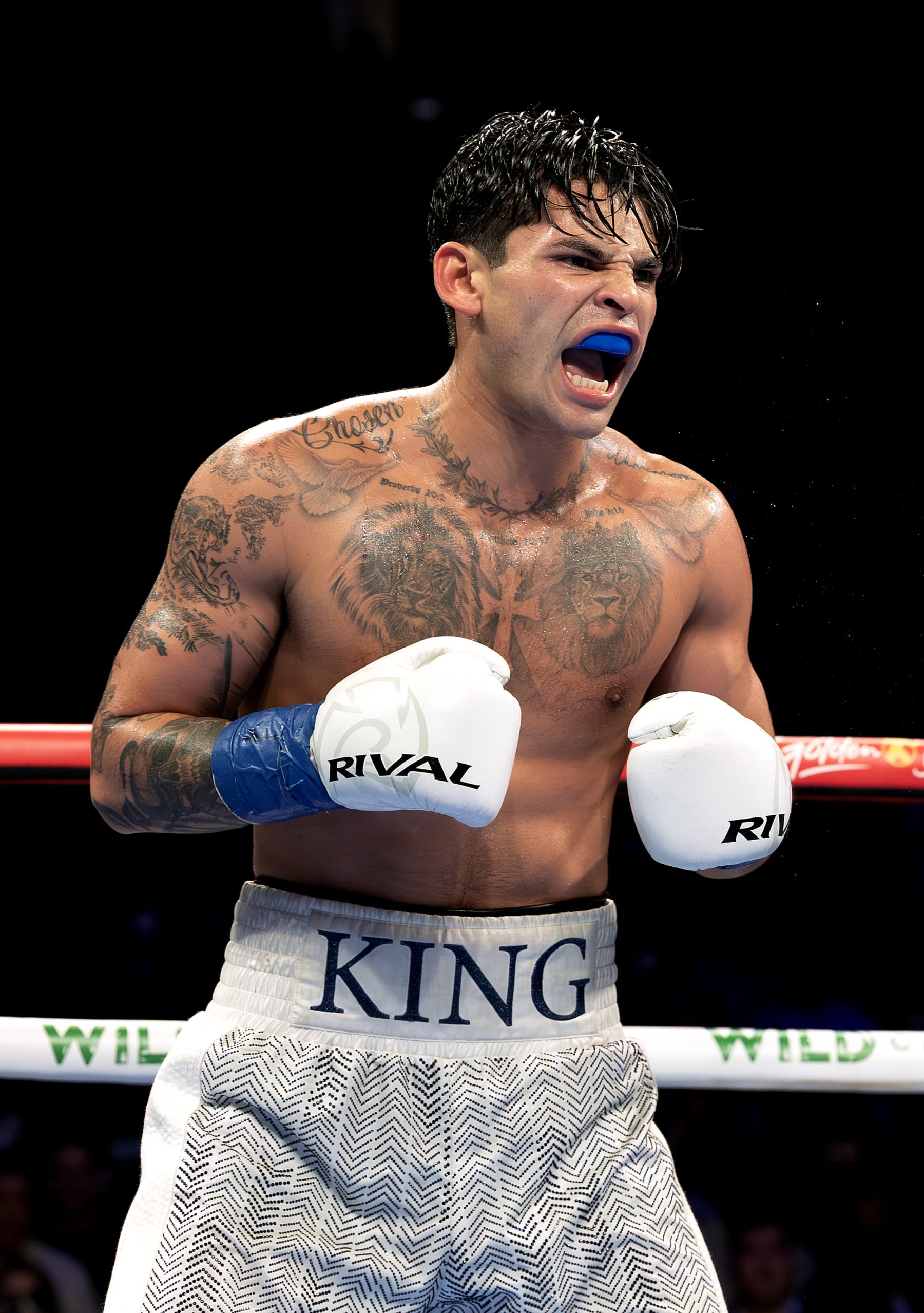 NEW YORK, NEW YORK - APRIL 20:   Ryan Garcia (white trunks) reacts against Devin Haney (gray trunks) during their WBC Super Lightweight title bout at Barclays Center on April 20, 2024 in New York City.  (Photo by Al Bello/Getty Images)