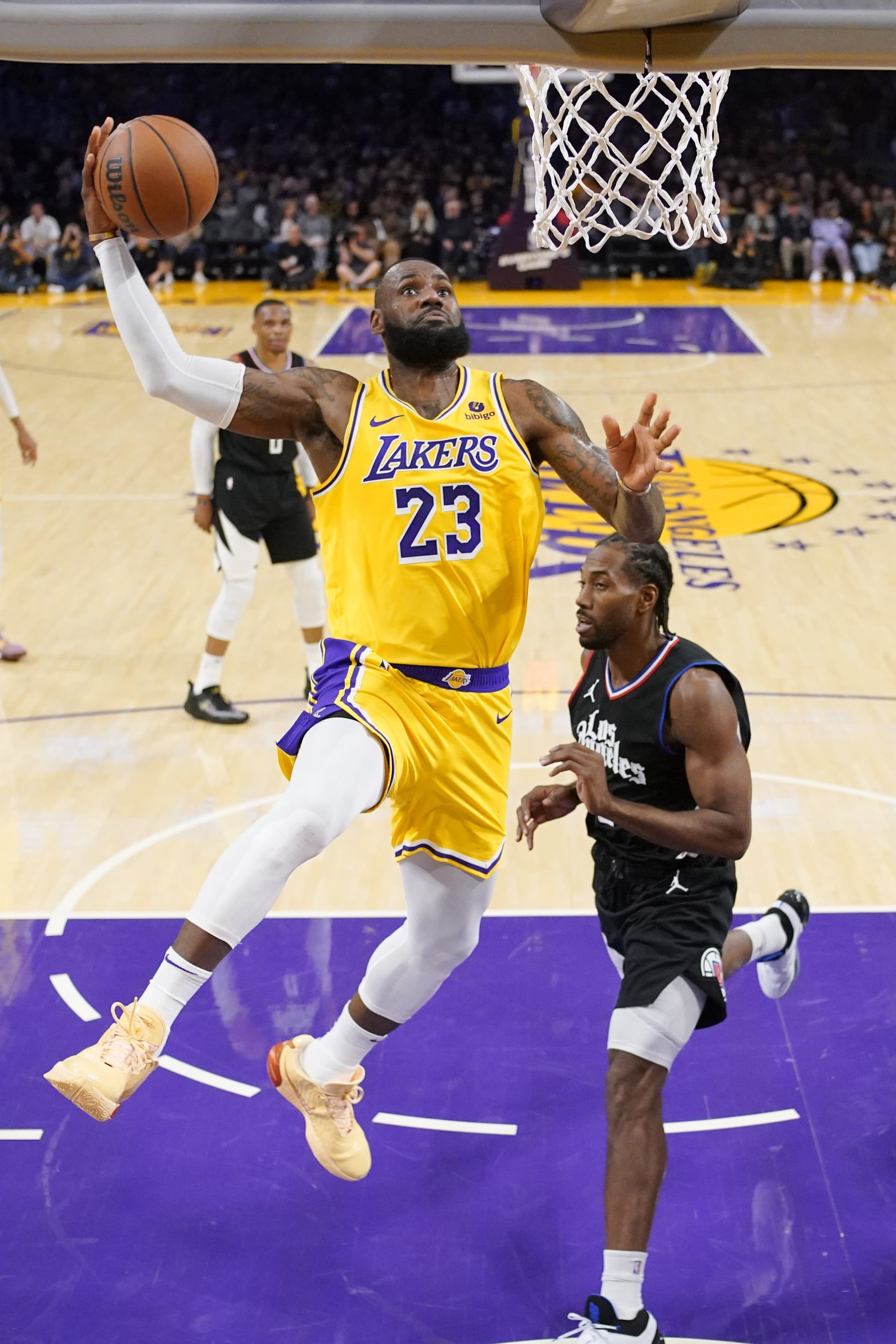 Los Angeles Lakers forward LeBron James, left, goes up for a dunk as Los Angeles Clippers forward Kawhi Leonard defends during the first half of an NBA basketball game Wednesday, Nov. 1, 2023, in Los Angeles. (AP Photo/Mark J. Terrill)